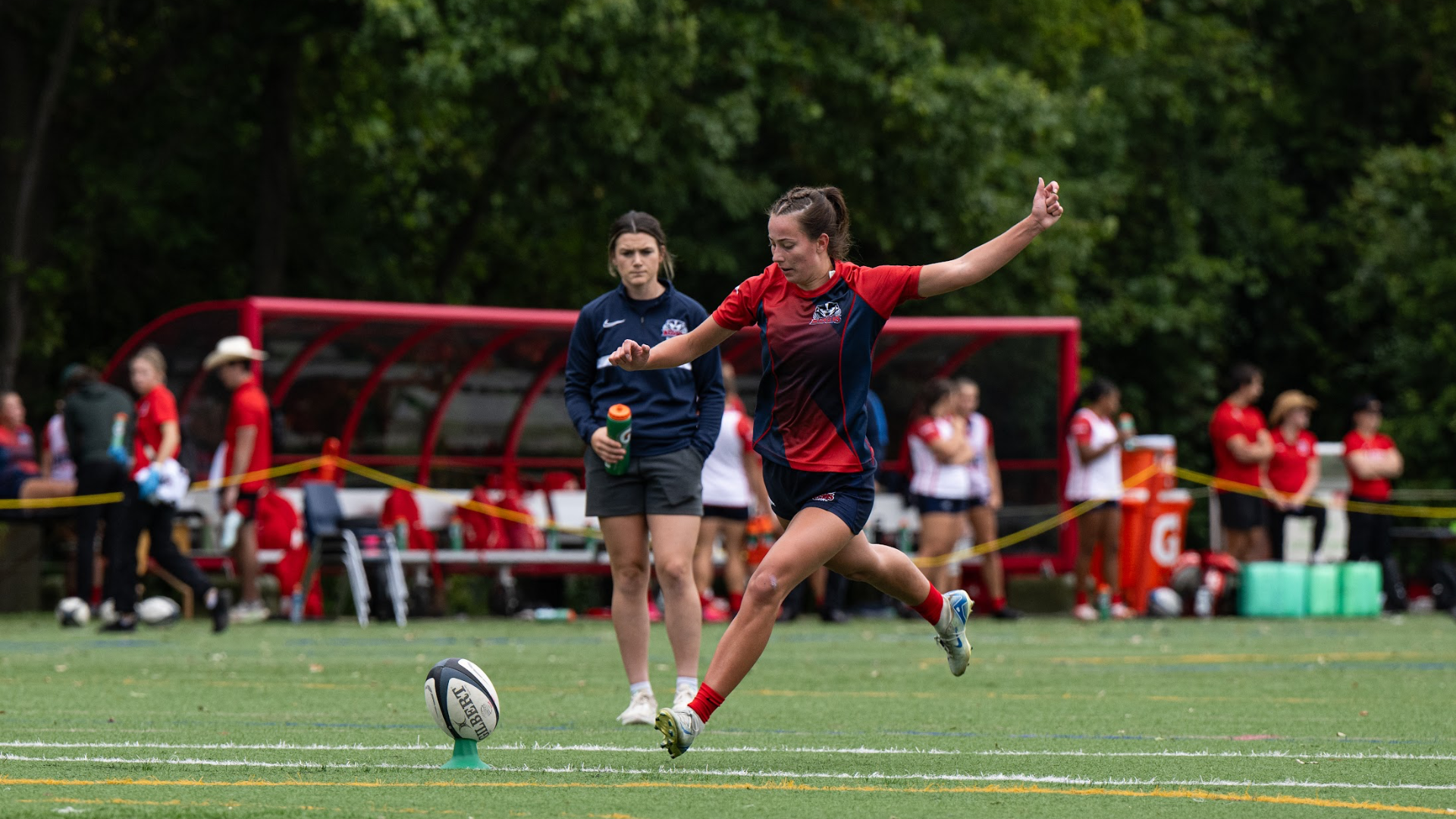A Brock women's rugby player prepares to kick a ball