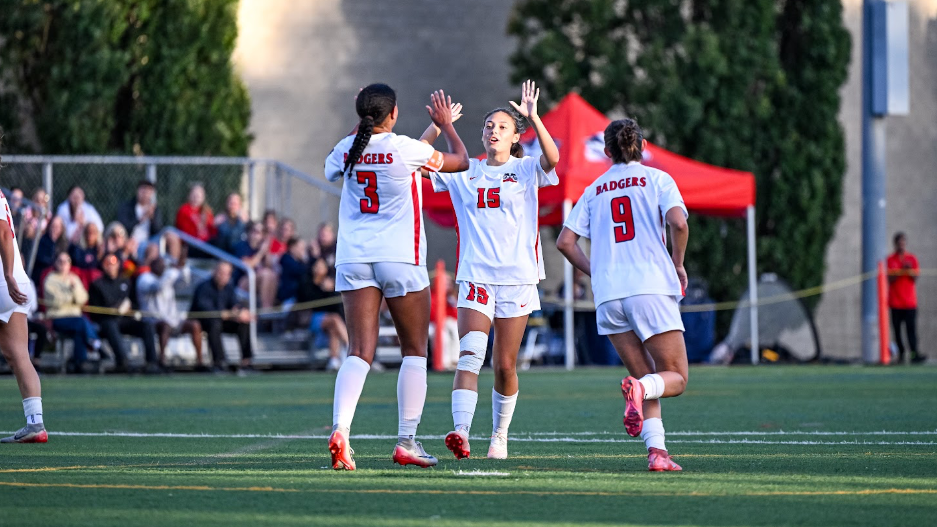 A pair of Brock women's soccer players high-five in celebration