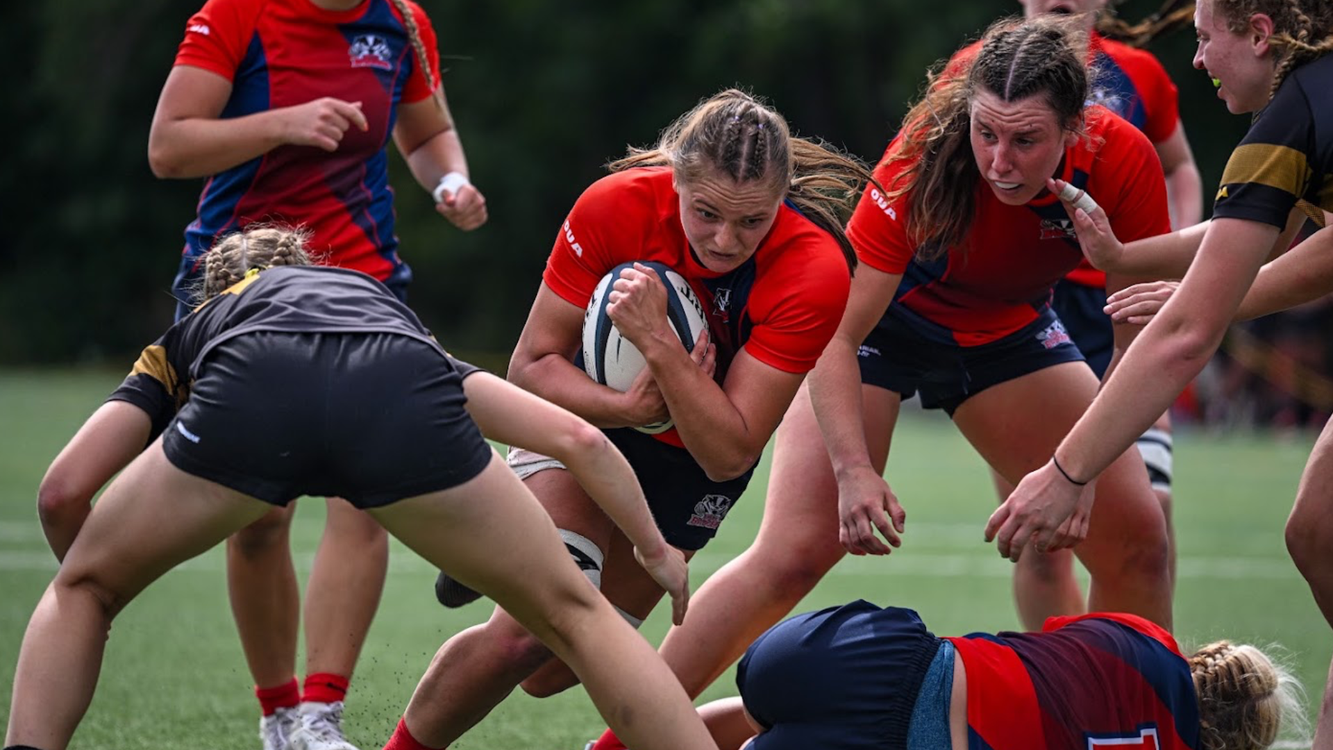 A Brock women's rugby player absorbs a hit