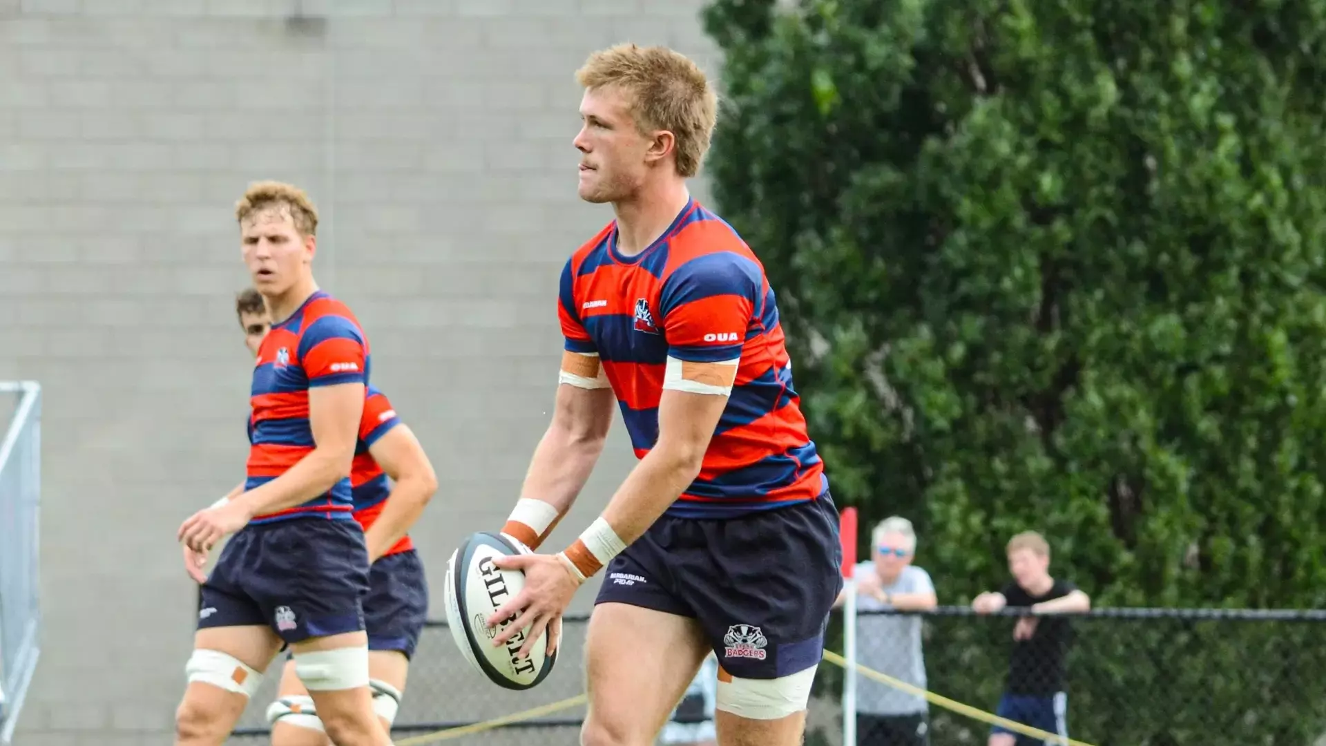 A Brock men's rugby player prepares to kick the ball