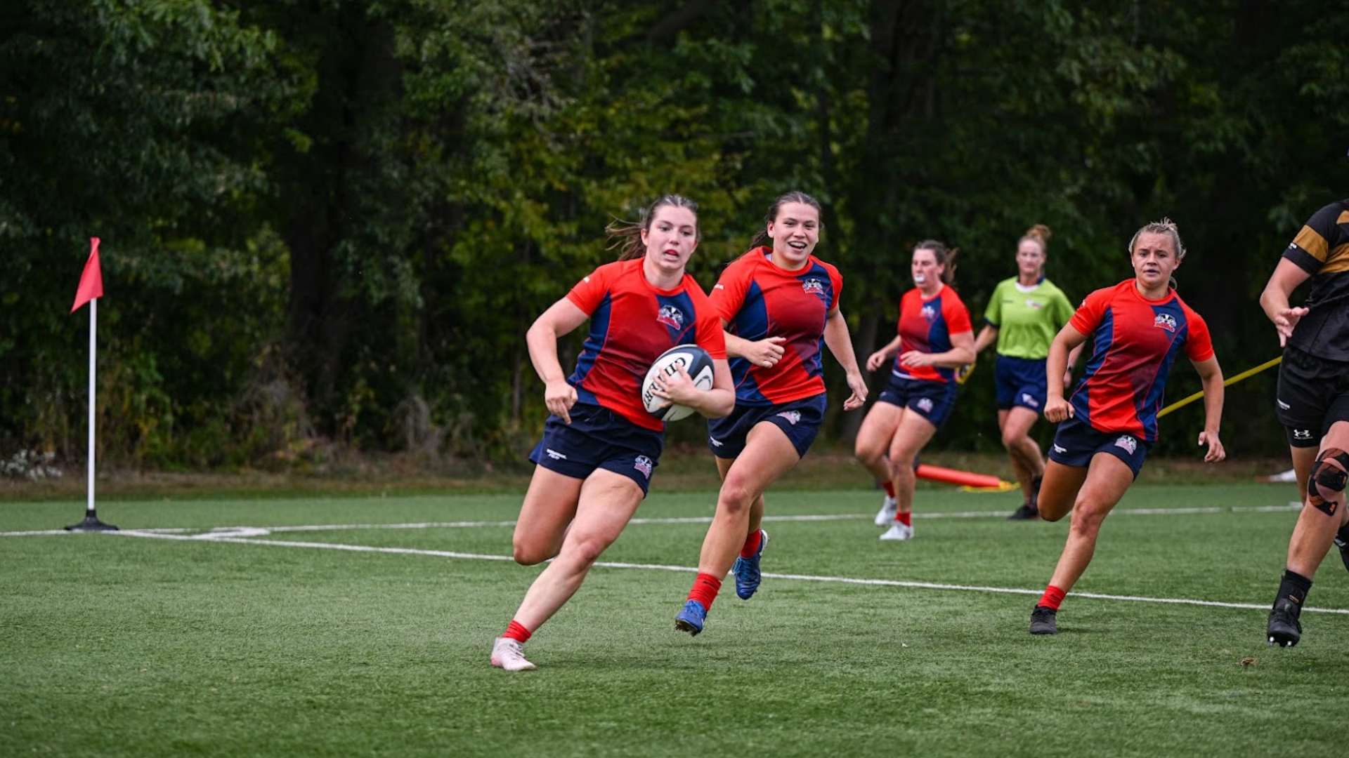 A Brock women's rugby player enters the try zone