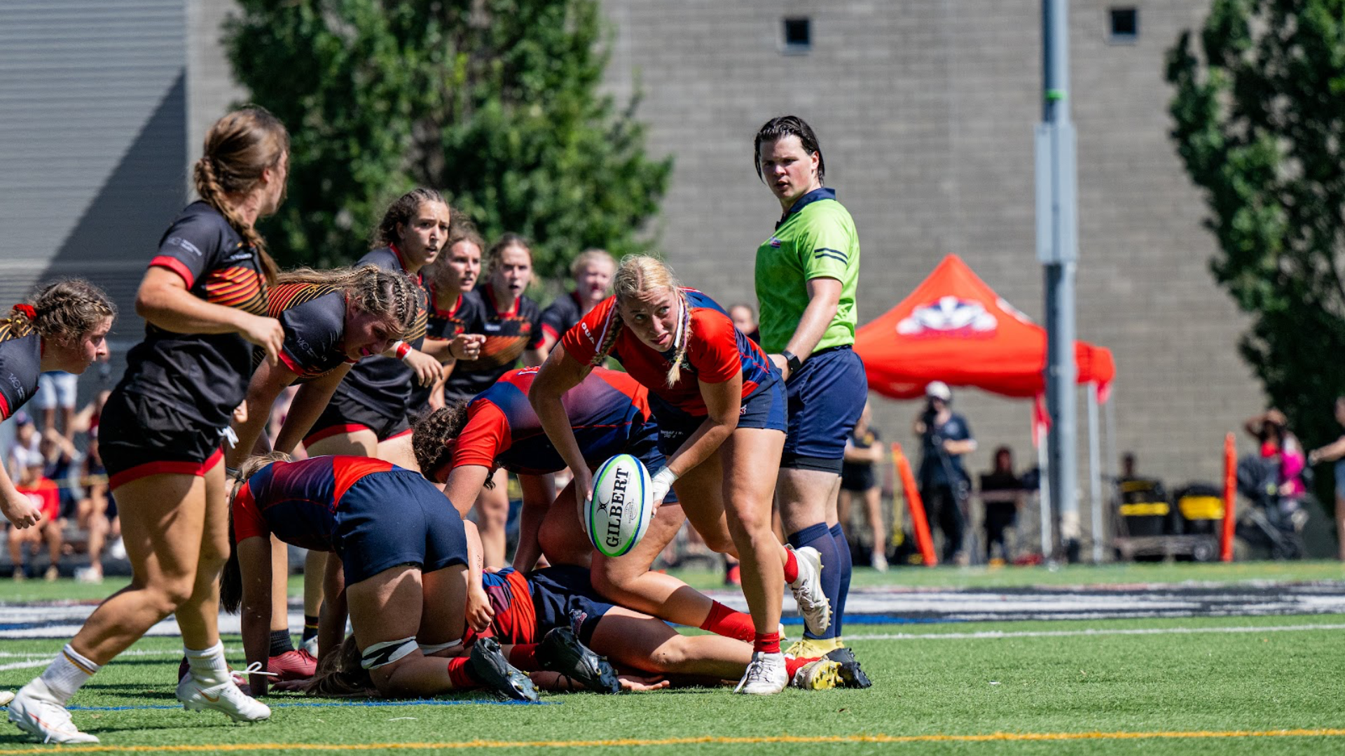 A Brock women's rugby plater passing the ball