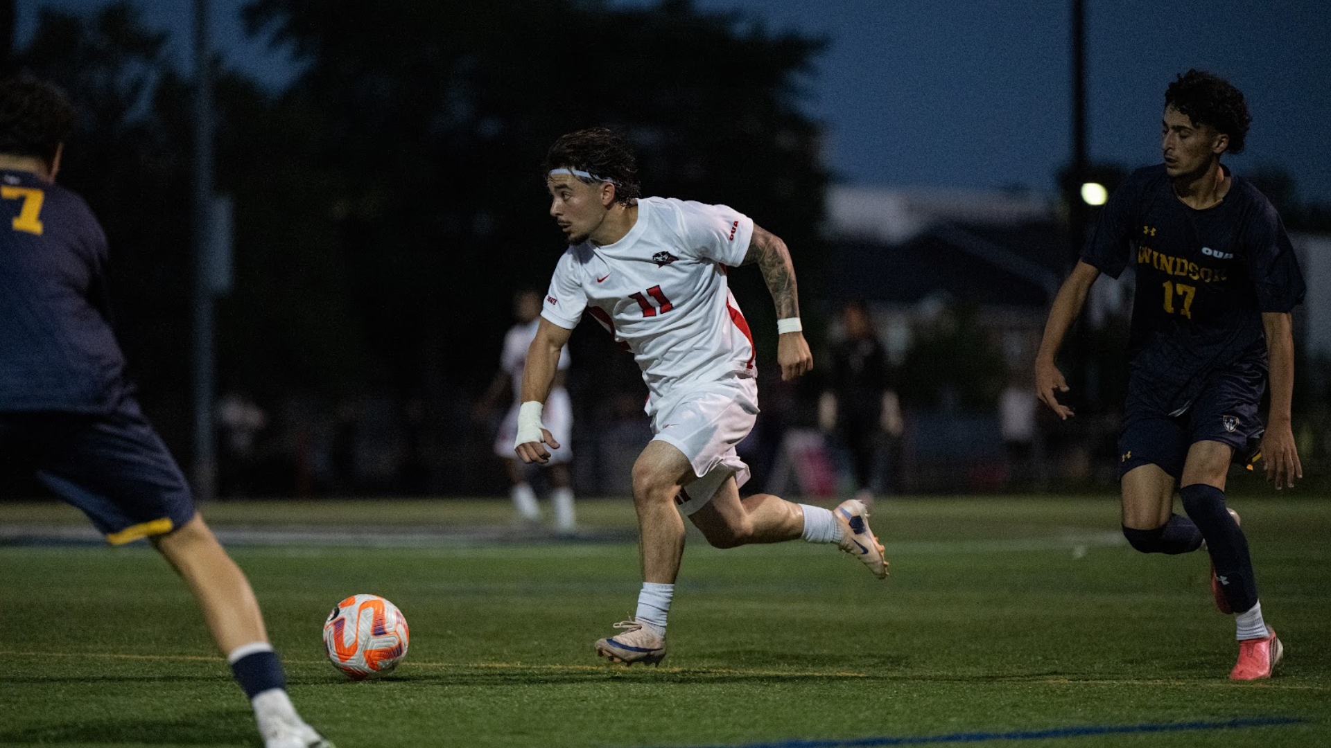 A Brock men's soccer player dribbling the ball