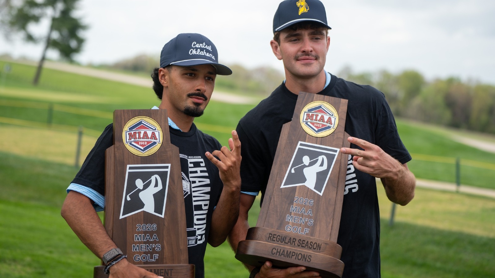 Nick Canales and Baylor Bostick Pose While Holding 2026 MIAA Championship Trophies