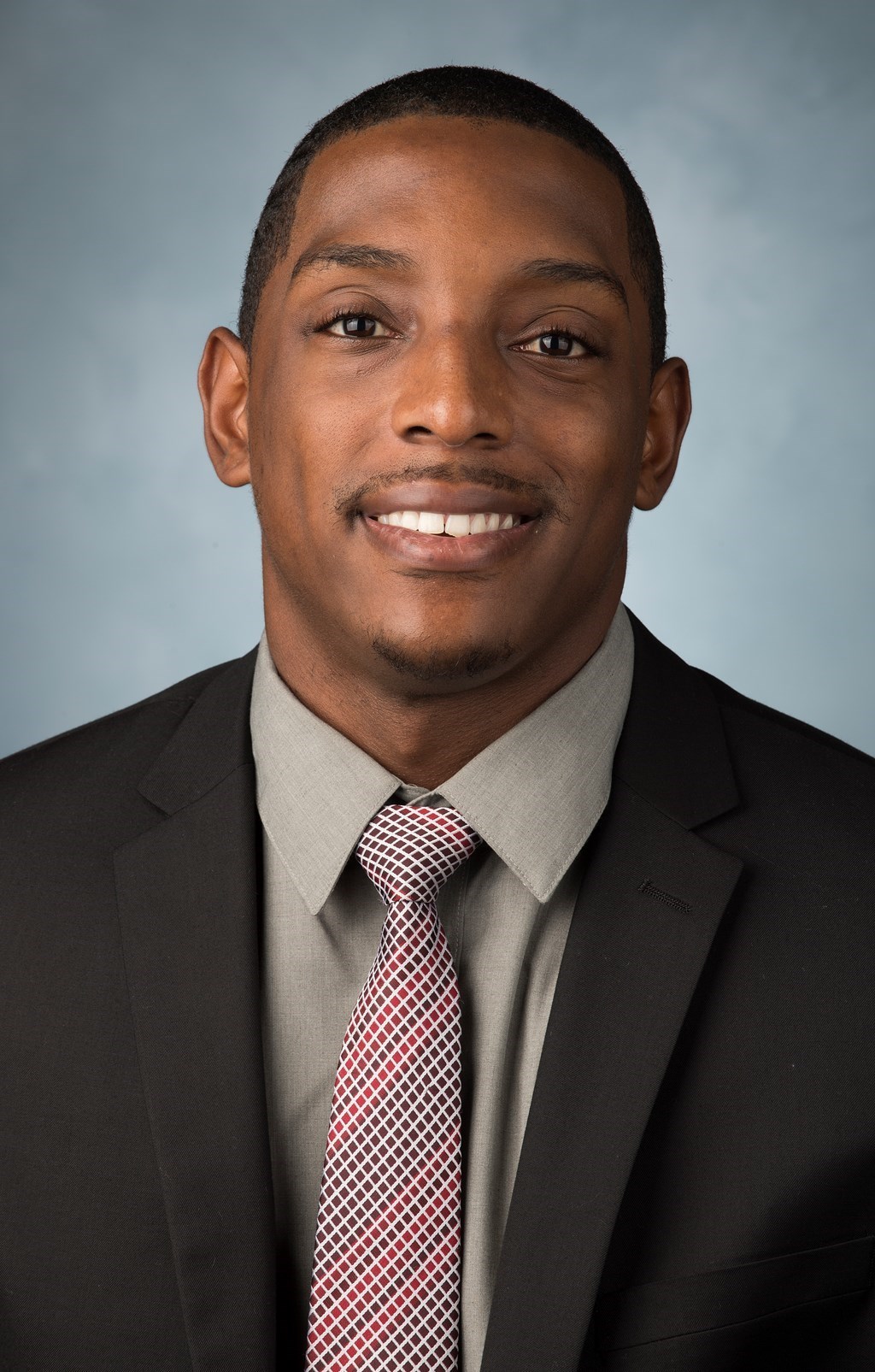 This is a head shot of  Berry Bell the program associate for the Men's Basketball team.
