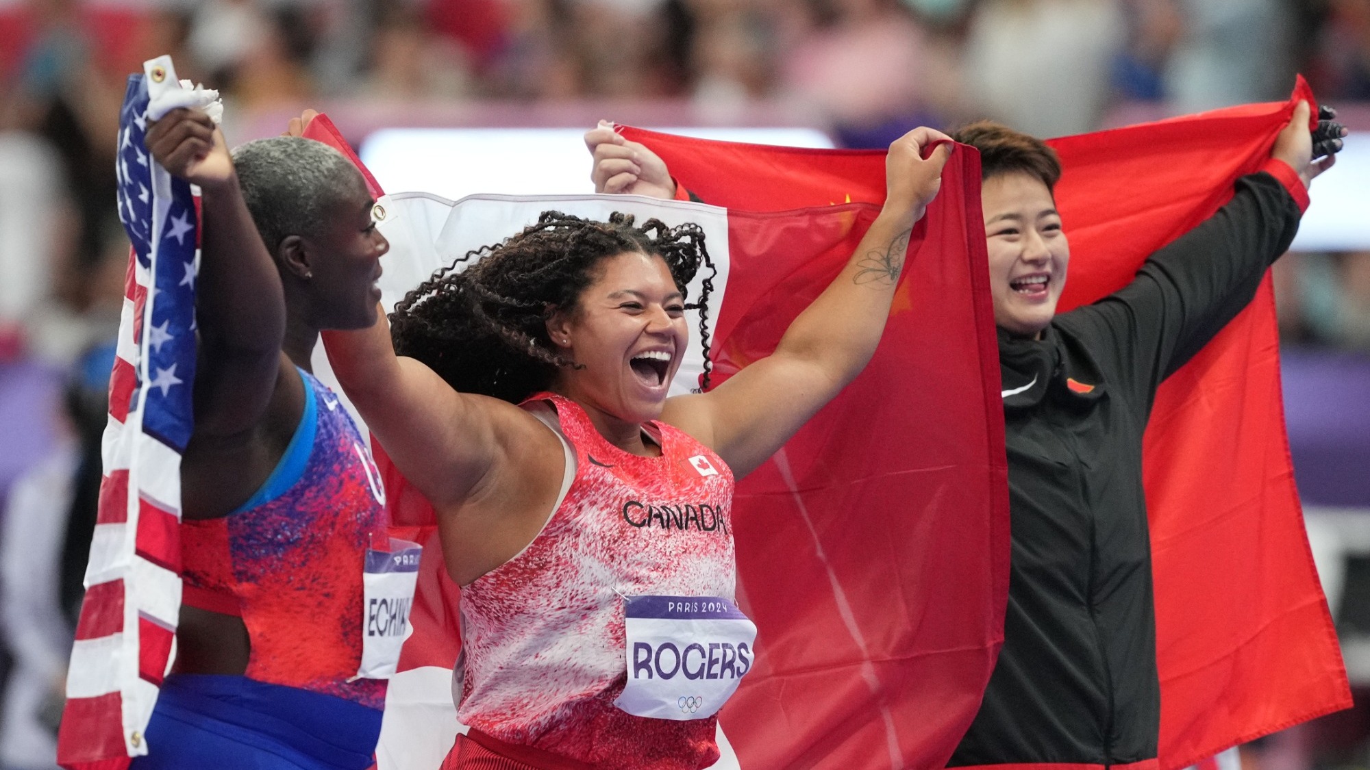 Aug 6, 2024; Saint-Denis, FRANCE; Gold medalist Camryn Rogers (CAN), silver medalist Annette Nneka Echikunwoke (USA) and bronze medalist Jie Zhao (CHN)  celebrate after the women's hammer throw final during the Paris 2024 Olympic Summer Games at Stade de France. Mandatory Credit: James Lang-USA TODAY Sports