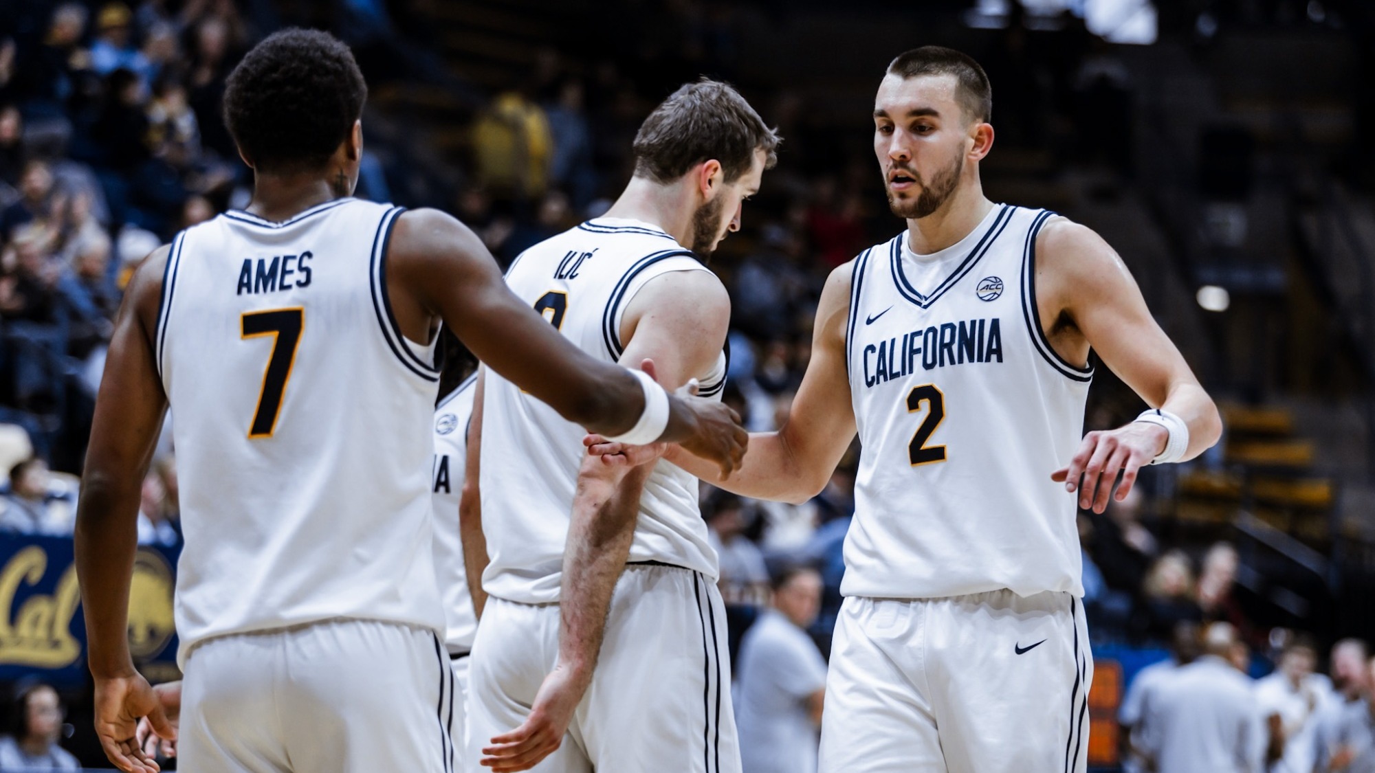 Dai Dai Ames and John Camden give each other five during a game at Haas Pavilion