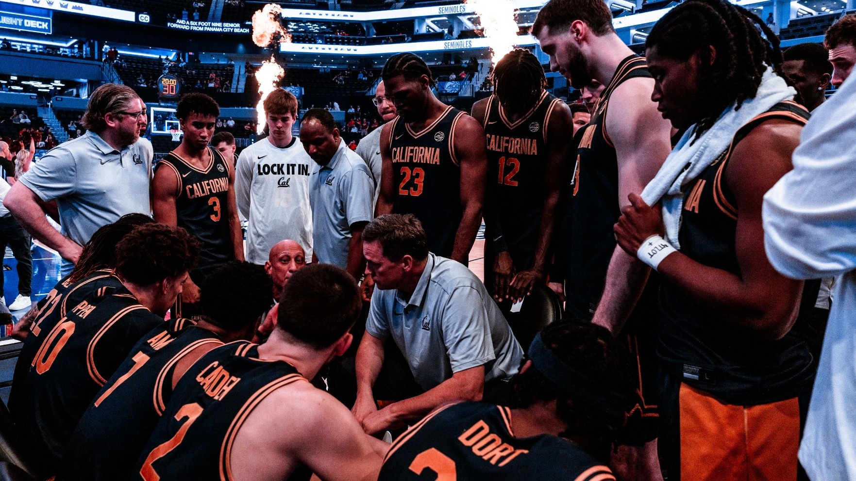 Cal coaches talk to the team on the bench before the ACC Tournament Second Round in Charlotte