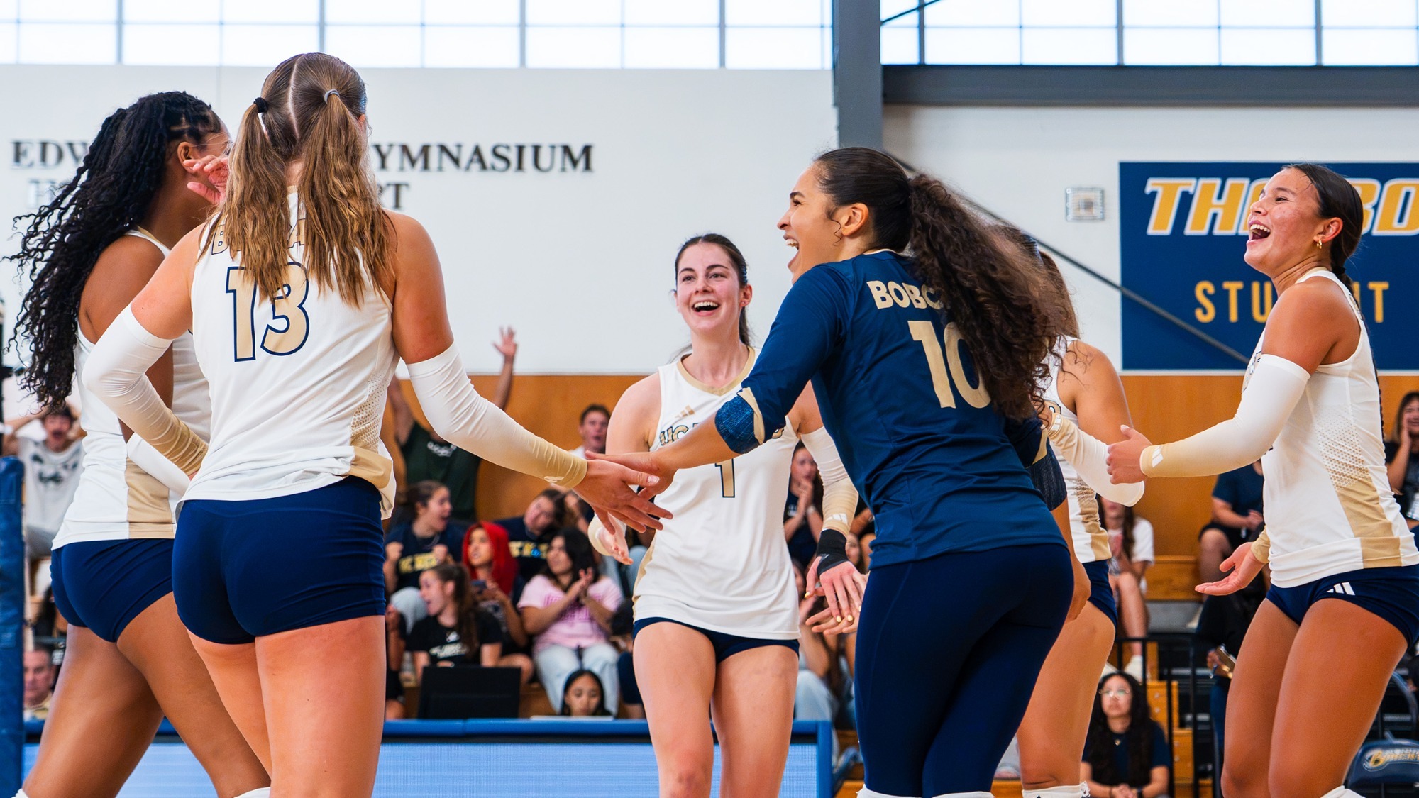UC Merced celebrating a point in a victory vs. Cal State Dominguez Hills. Kyra Miller is in the center.