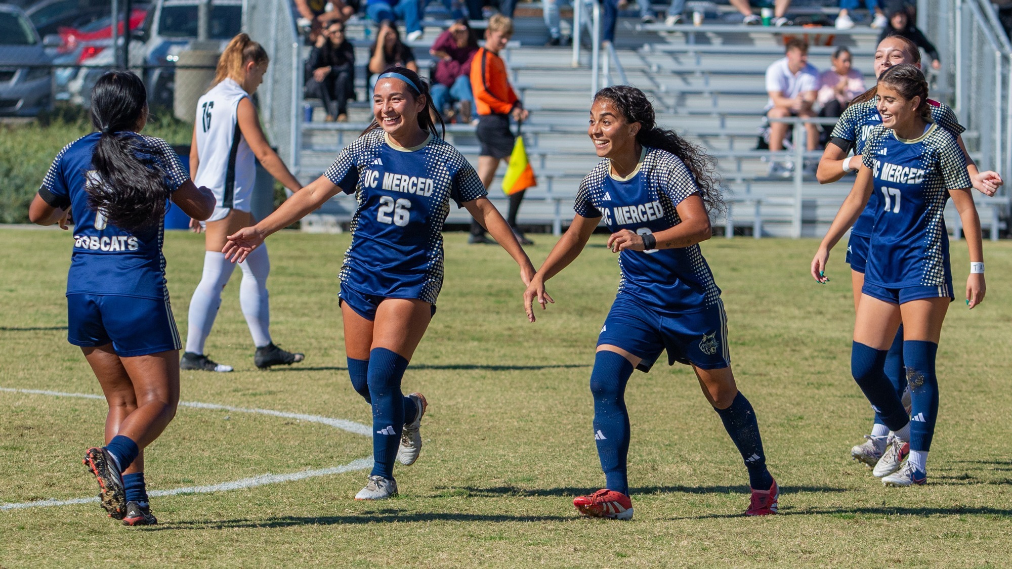 Jackie Tamayo and Jocelin Roa celebrating a goal with other teammates on a Senior Day win on Bobcat Field