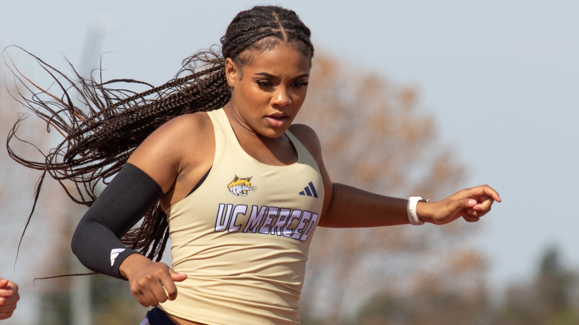 Jordynn Lewis crossing the finish line in the 100m dash at the Kim Duyst Invitational.