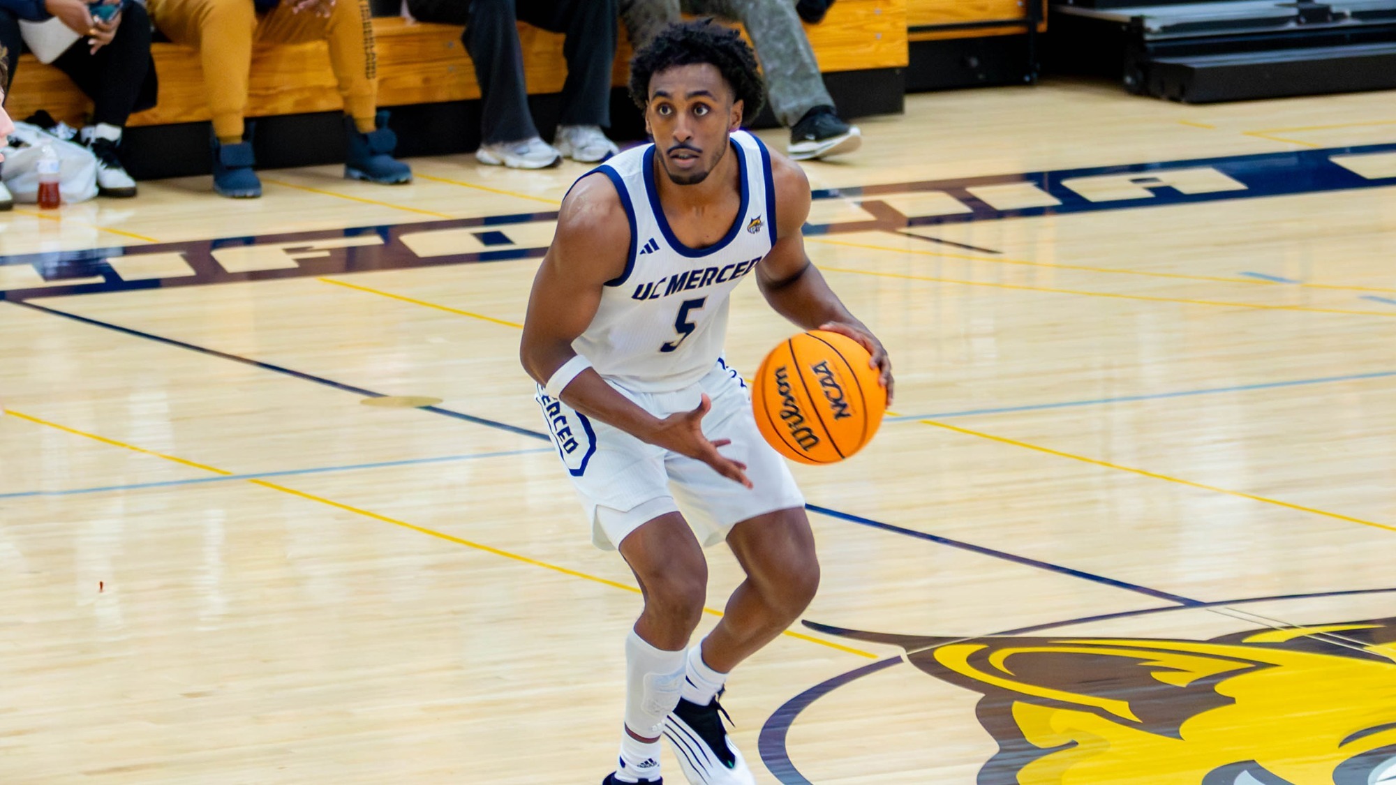 Pawllos Habtom making a basketball move on Hostetler Court