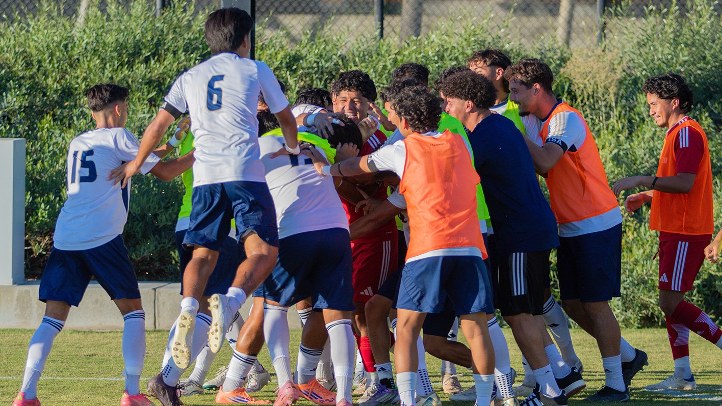 UC Merced men's soccer celebrating after a goal.