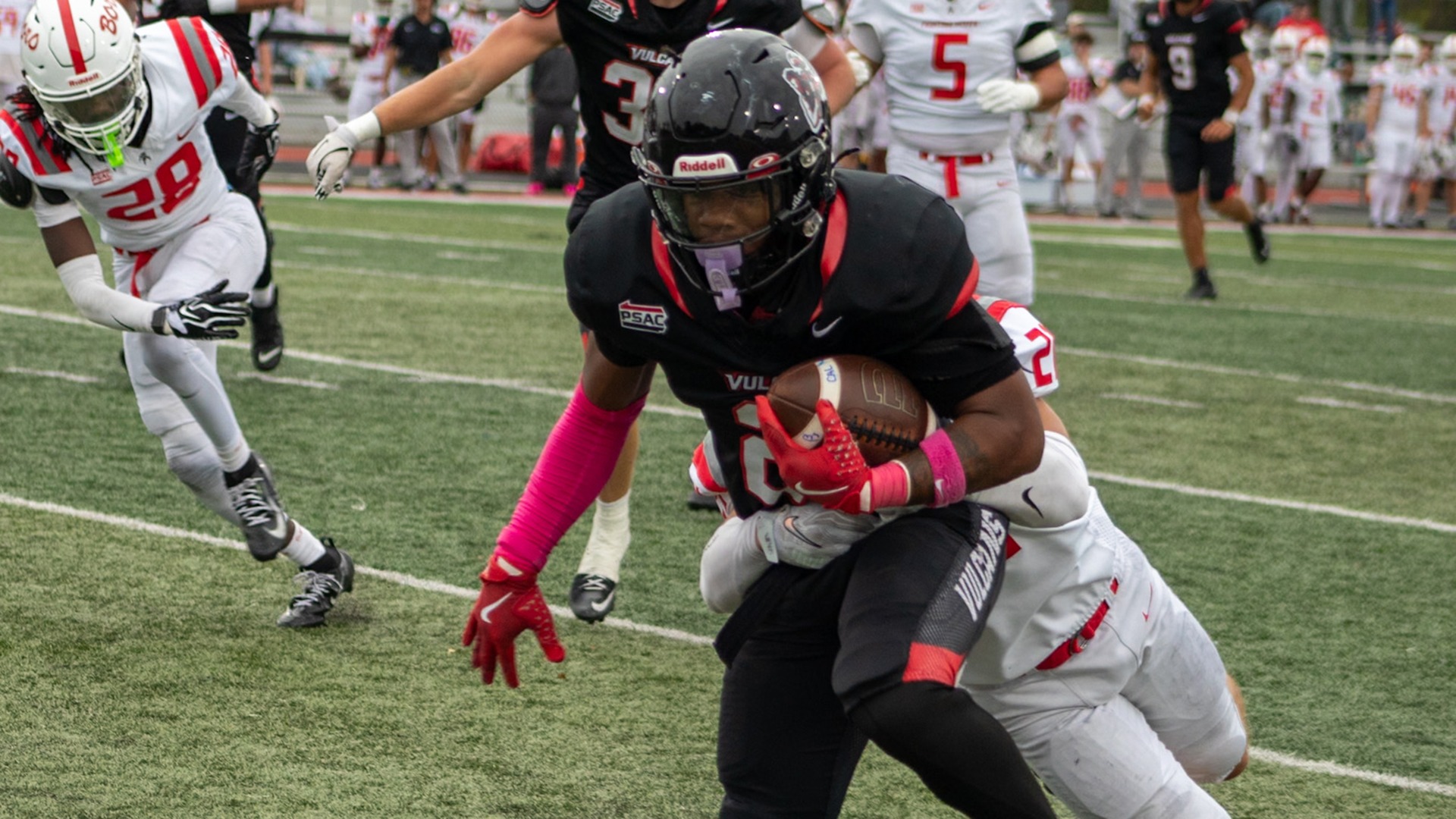 California running back Bobbie Boyd Jr. carries the football while shedding a tackle during a game.