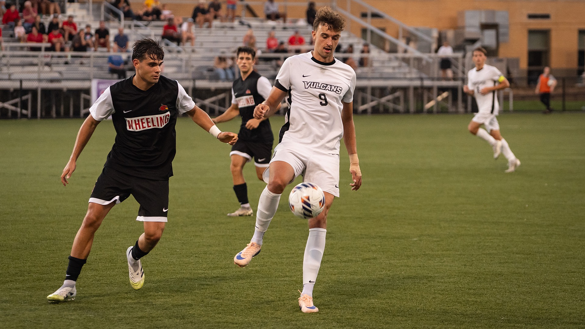 California men's soccer player Filip Barta (No. 9) controls the ball mid-air with his foot while defended by a player on the field.