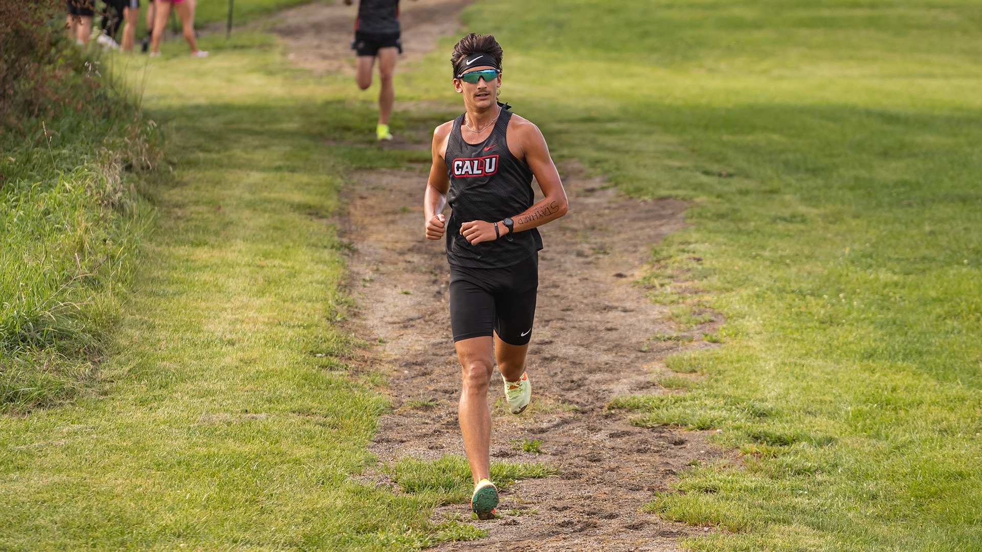 Garret Minnick, wearing a black headband, sunglasses, and a black 