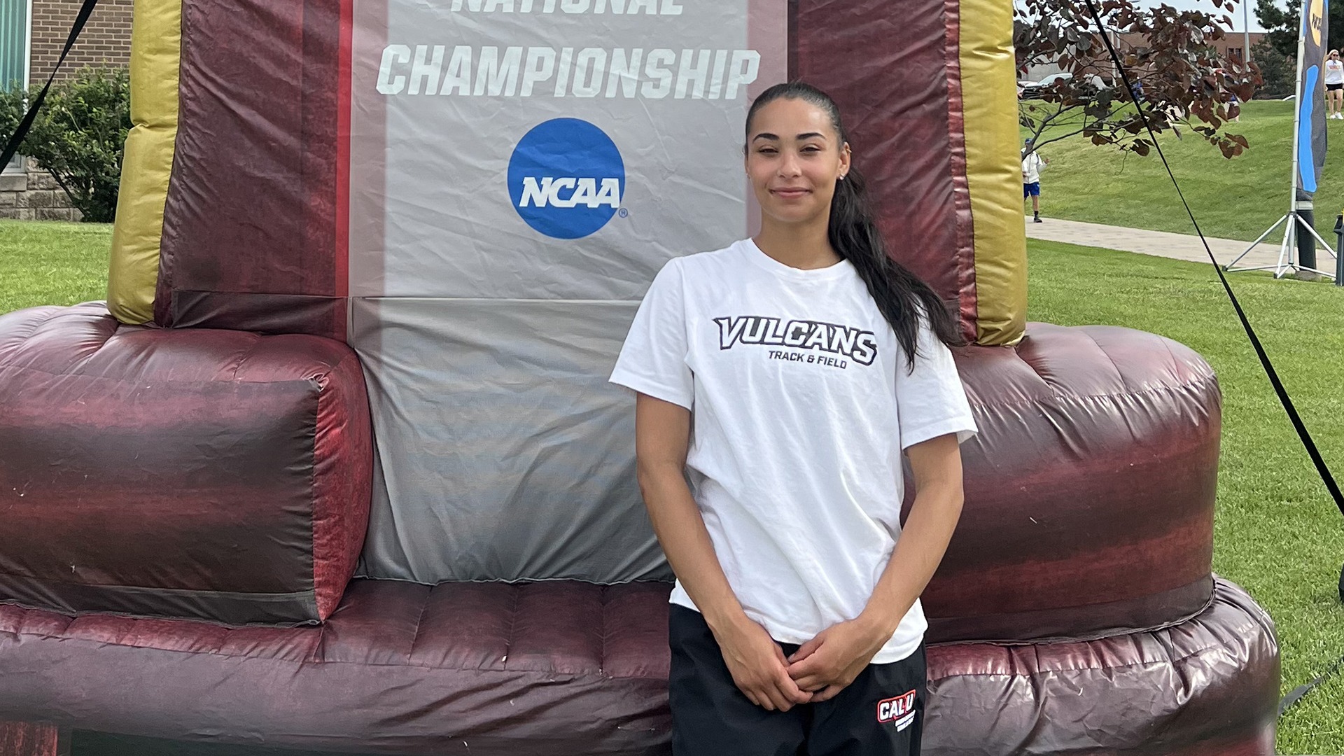 California sophomore Brianna Lee standing next to large inflatable trophy at 2026 NCAA Championships in Kansas.