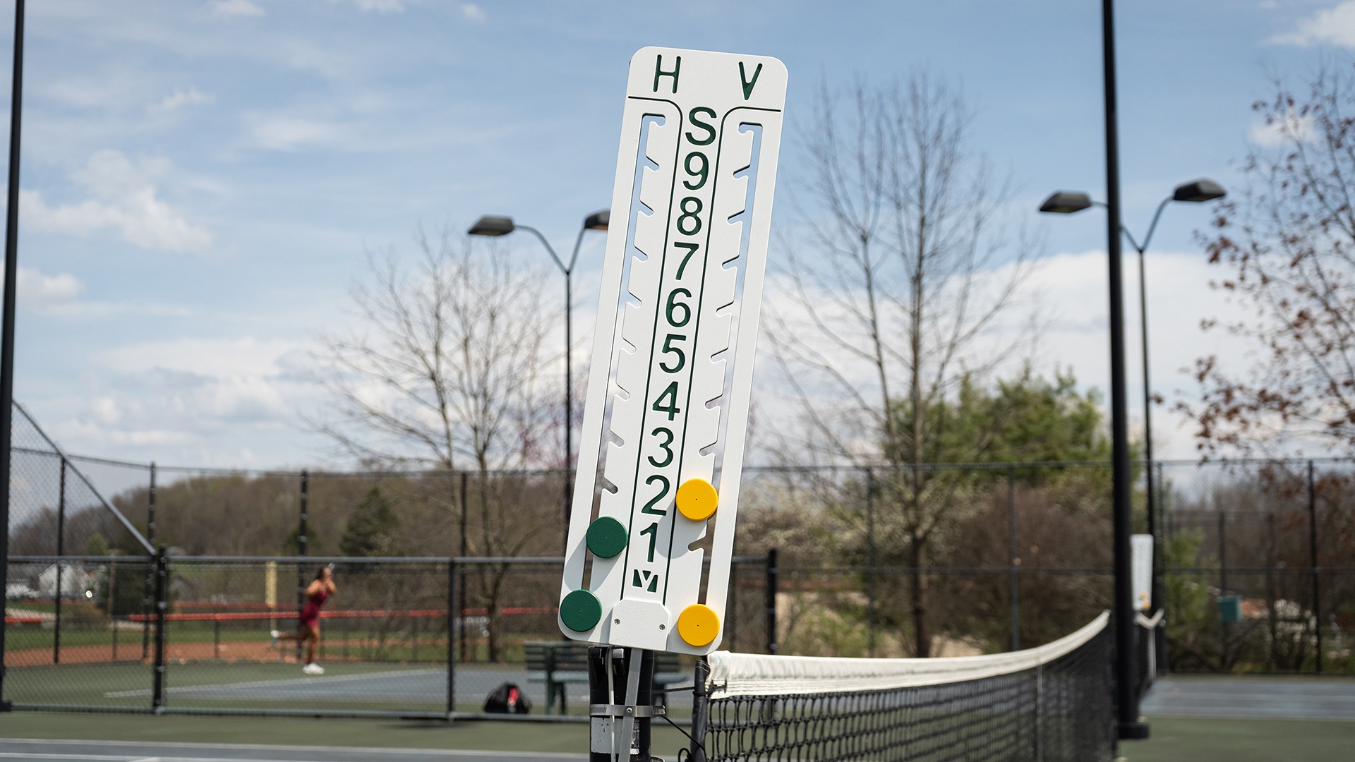 tennis scoreboard during match at roadman park in spring