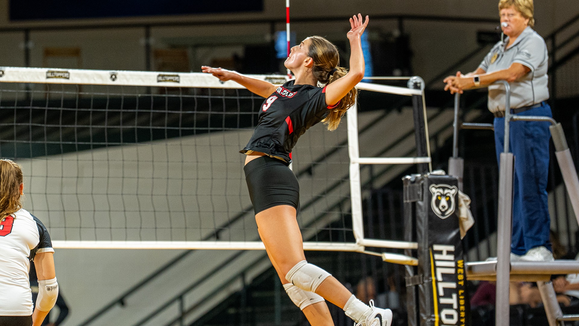 Freshman volleyball player Madelyn Salisbury leaps near the net to strike the ball during a match against Fairmont State.