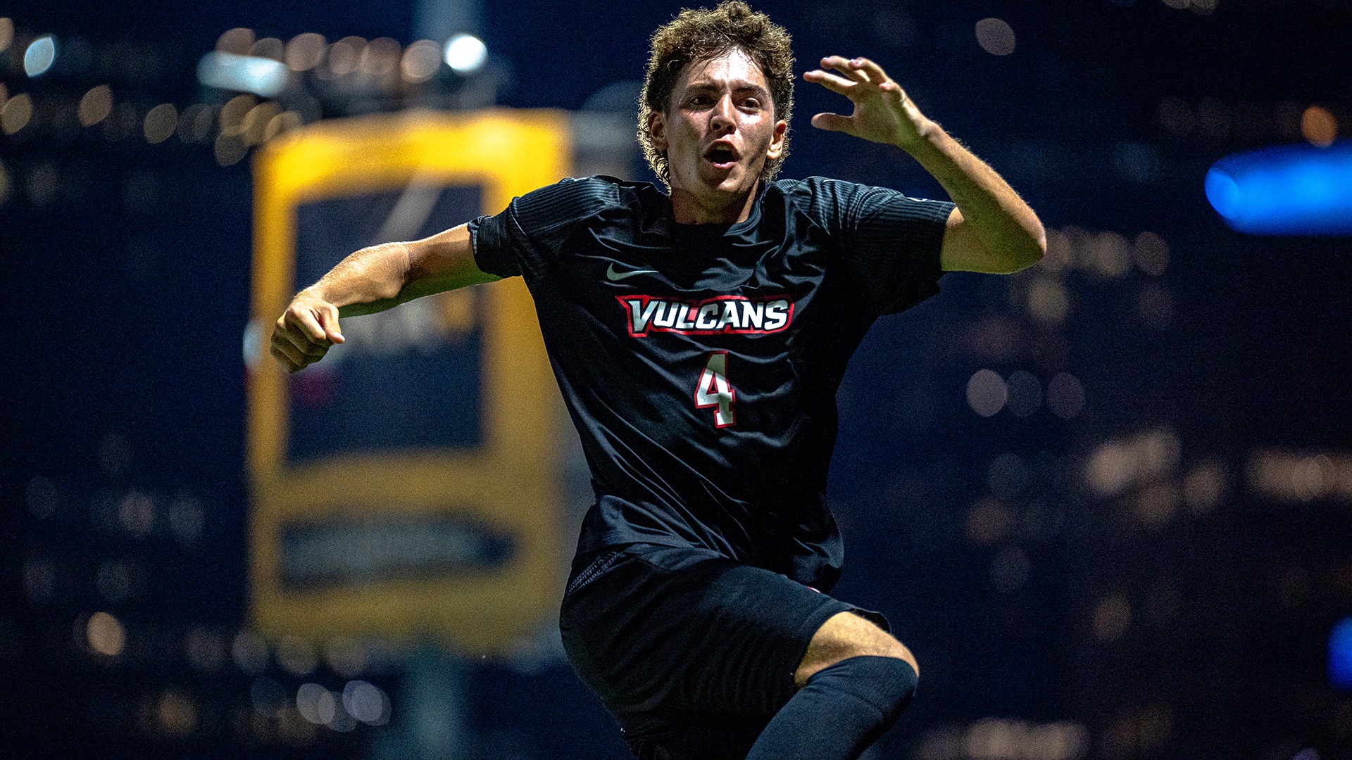 Brayden Alvarez (#4) runs with open arms and an excited expression as he celebrates scoring a goal during a night game in Pittsburgh.