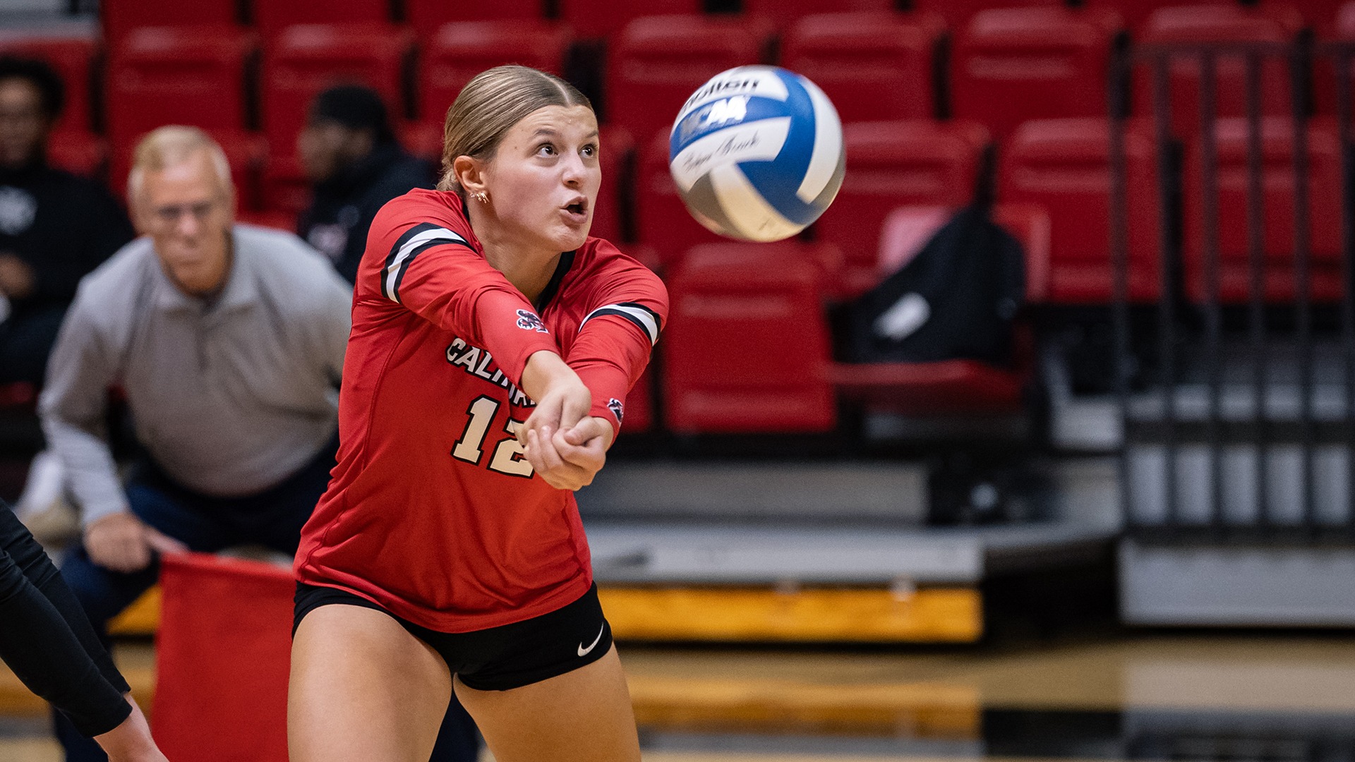 California volleyball player Olivia Weiseman passing a volleyball in mid-air during a match.