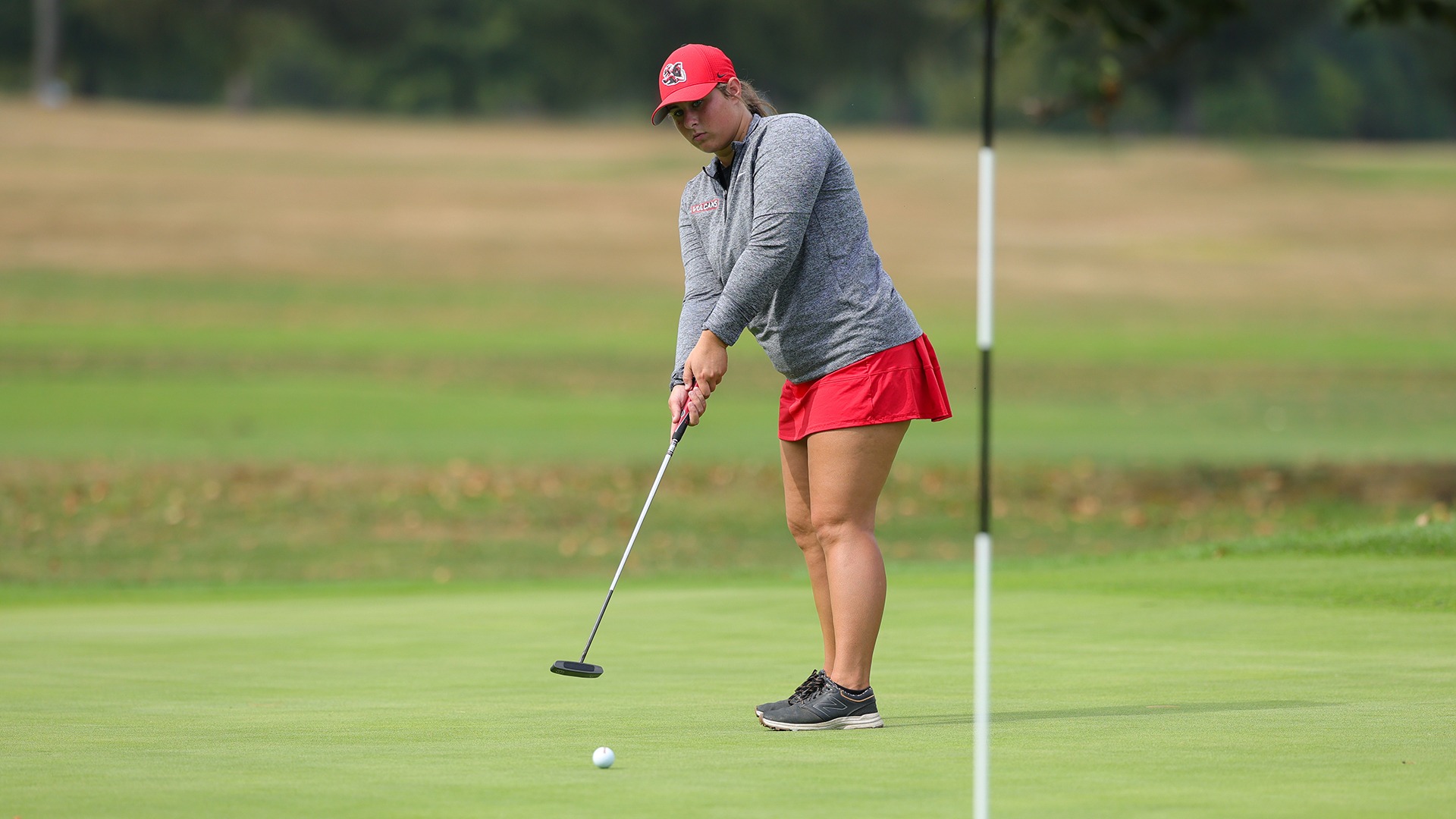 Golfer Victoria Scaramucci lining up a putt on the green during the 2025 Vulcan Invitational.