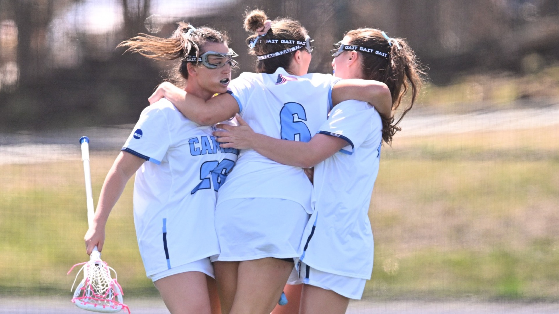 Campbell Johnston, Suzie Smith, and Sophia Virgilio celebrating a Camels goal.