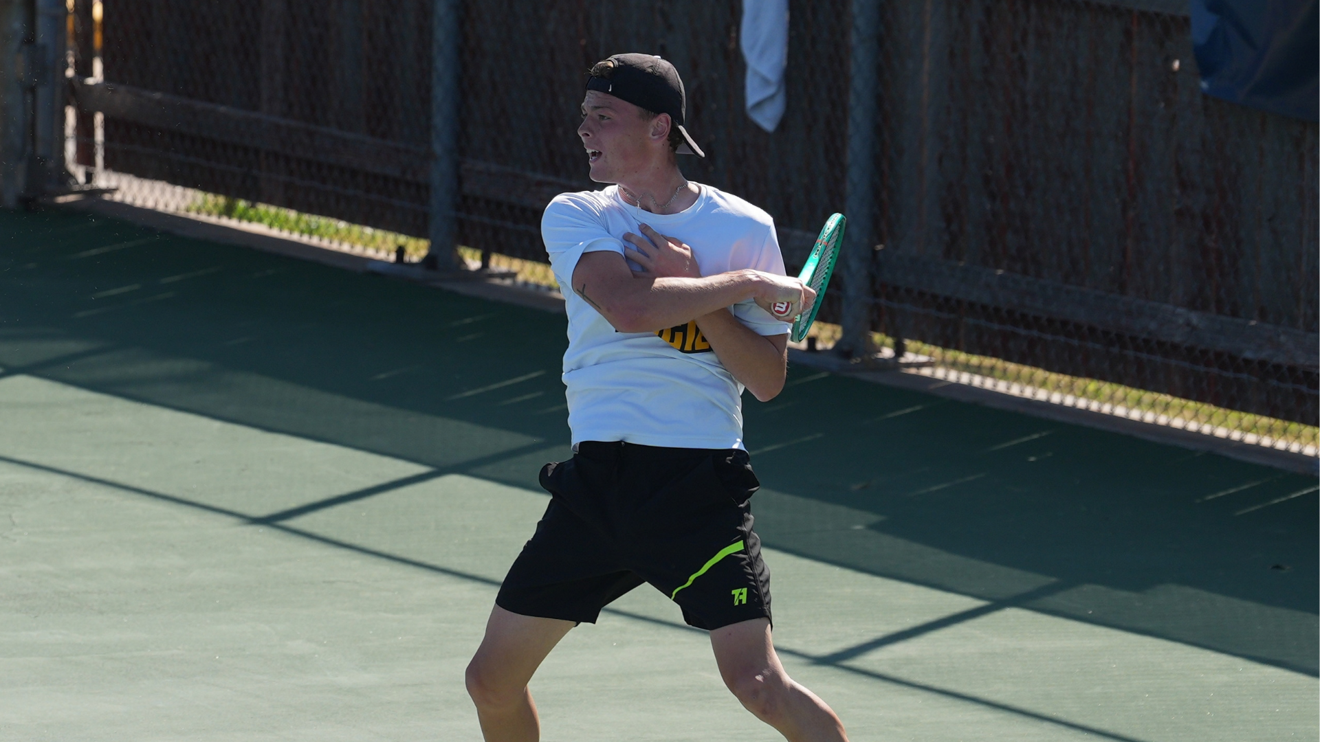 Cameron University men's tennis player follows through on a forehand shot during a match at the Midwestern State Invite.