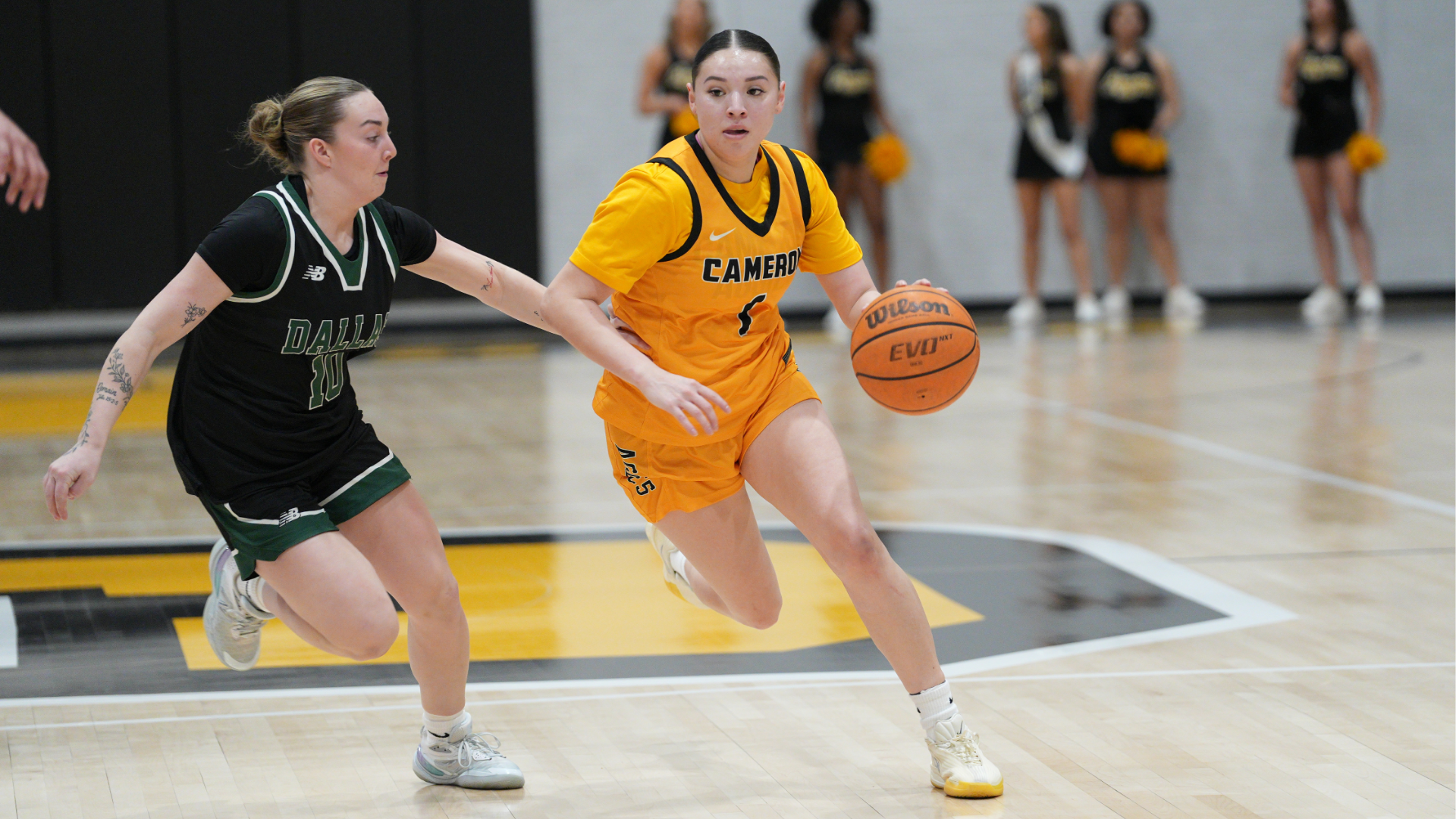 Cameron Women's Basketball player dribbling the basketball around a defender