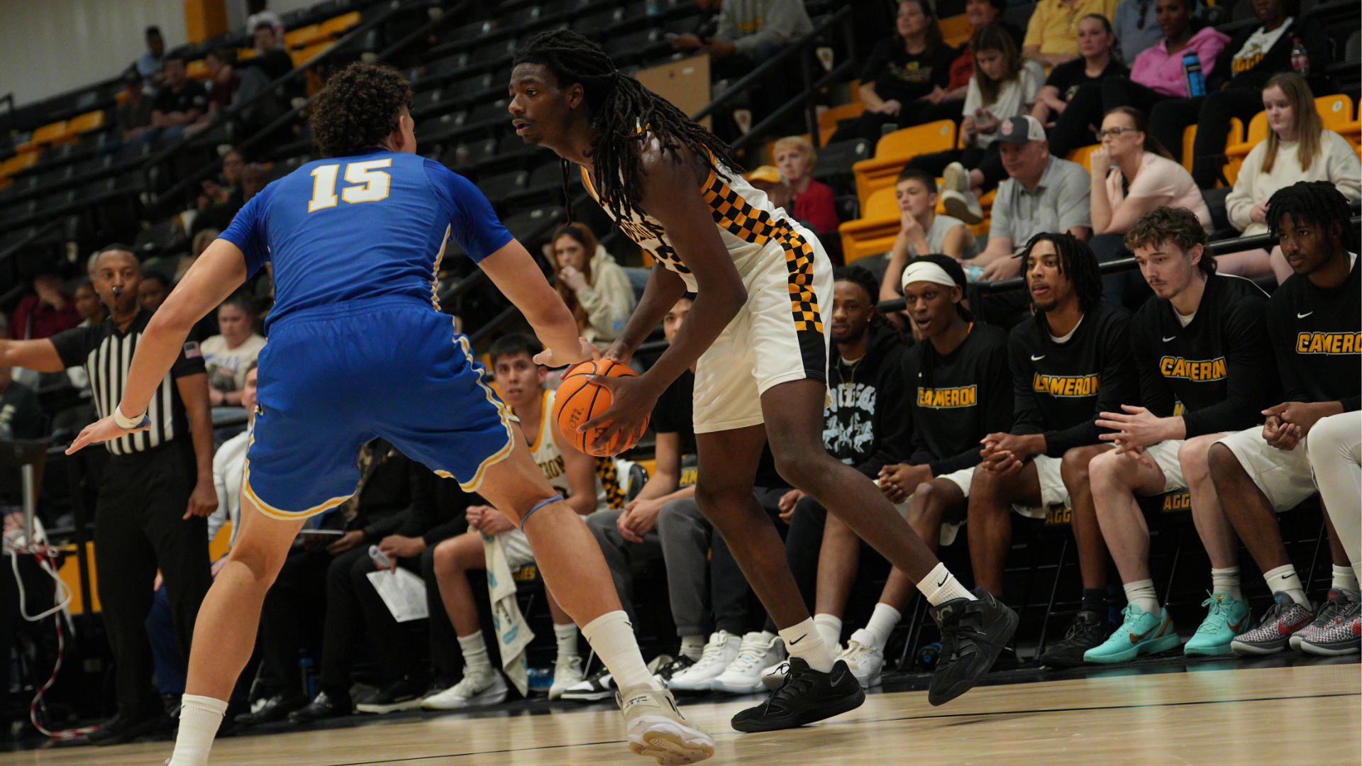 Cameron Men's basketball player with ball in hand guarded by St. Mary's player
