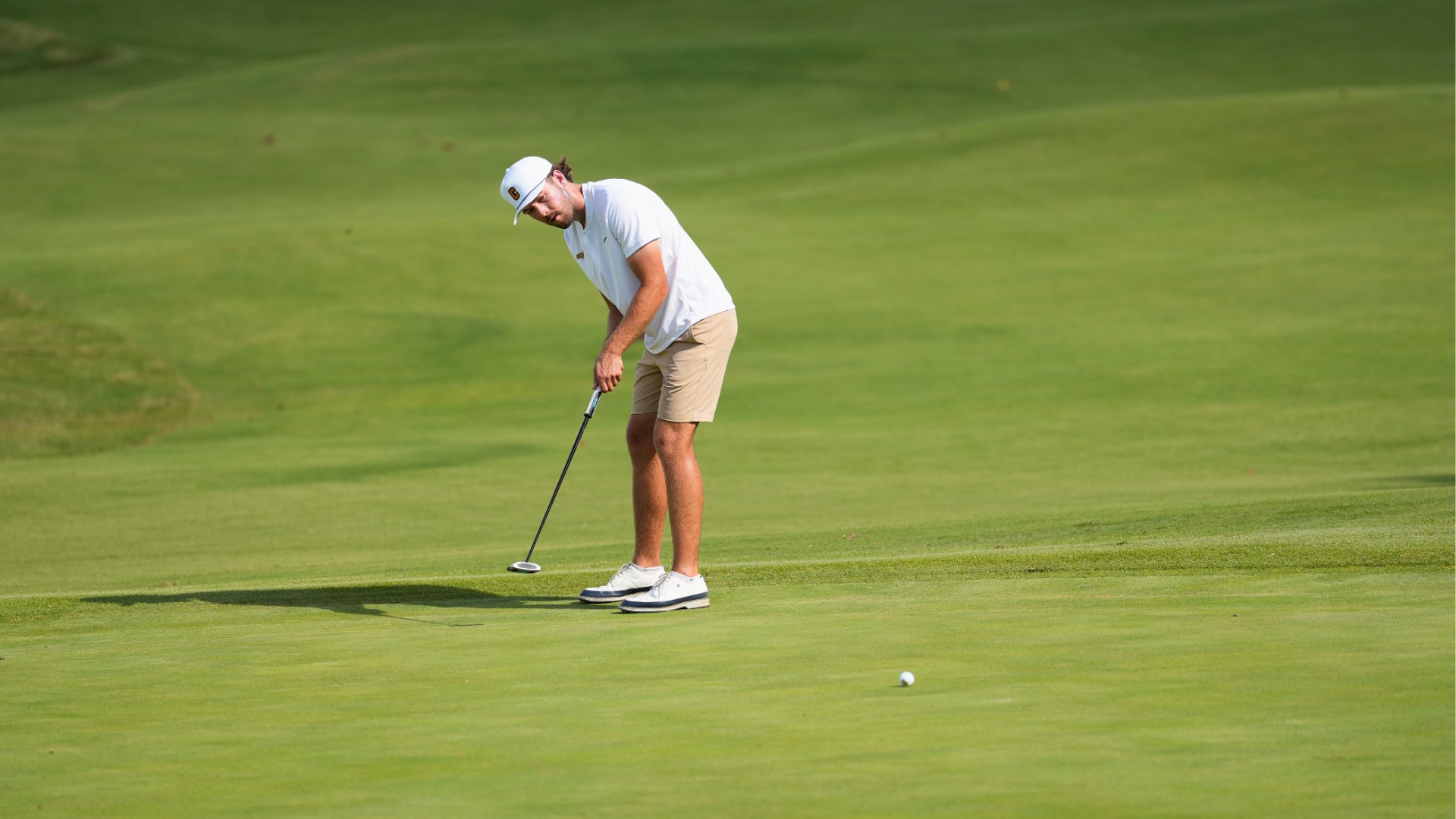 Cameron men's golfer hitting a putt