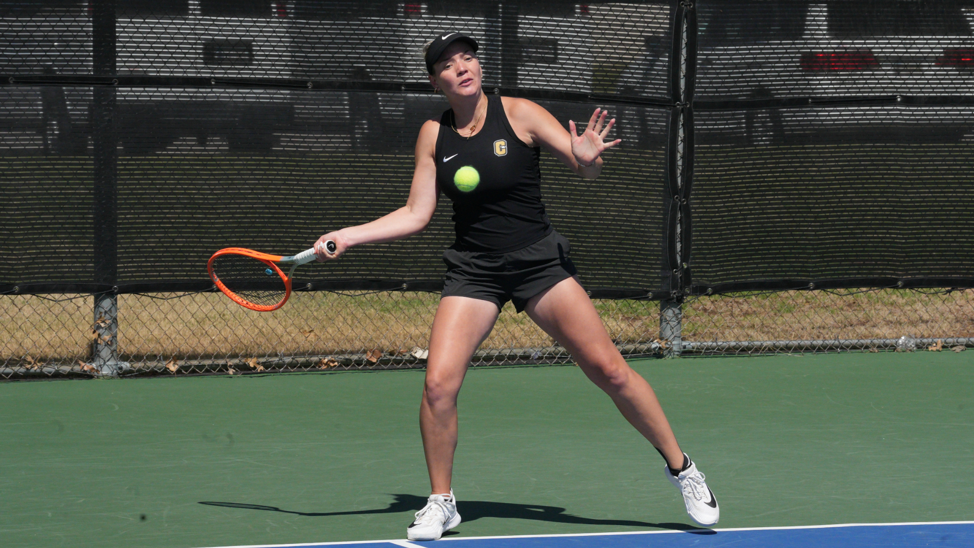Cameron women's tennis player hitting a forehand