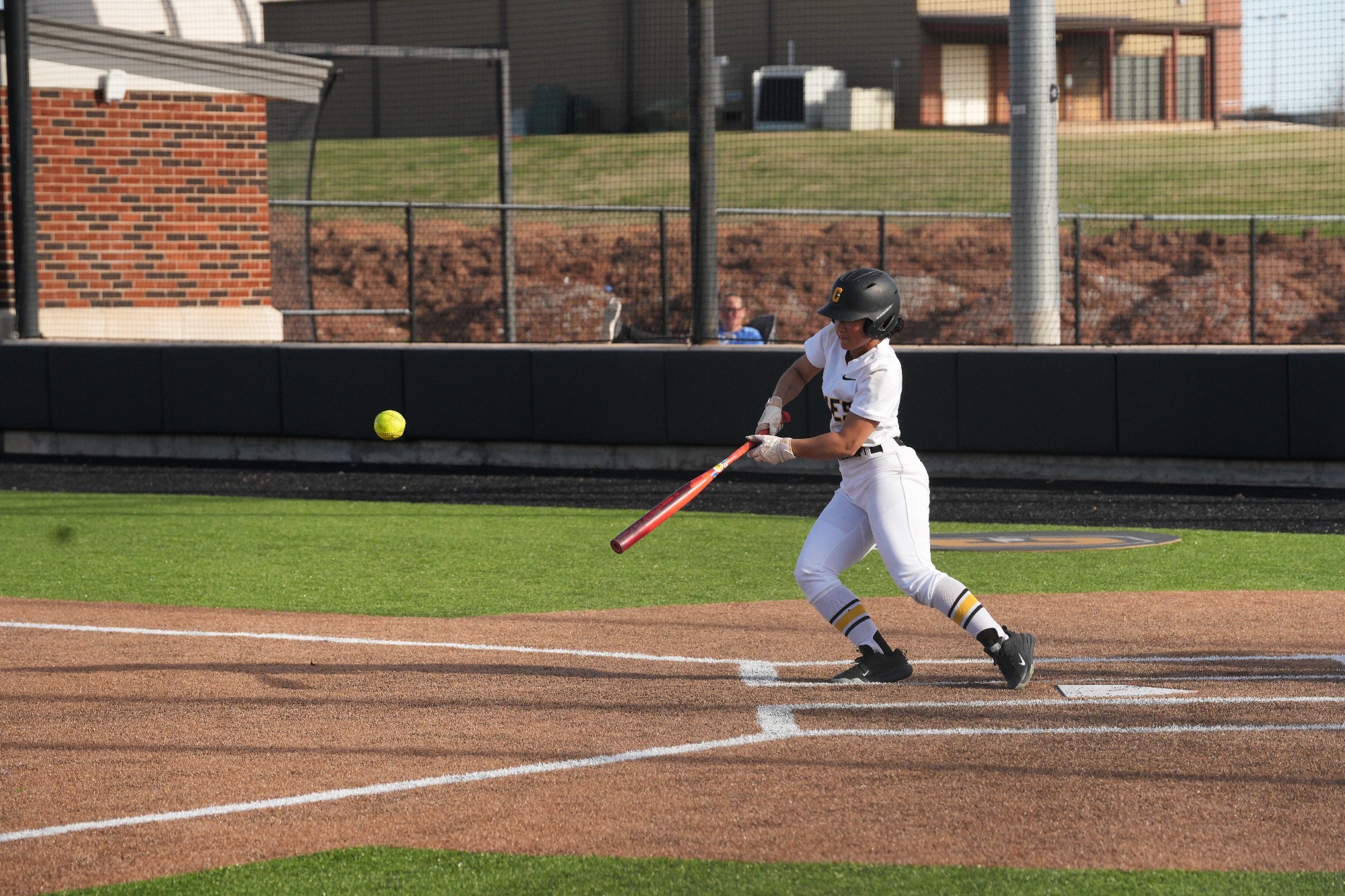 Cameron softball player, Chloe Broussard, hits the ball