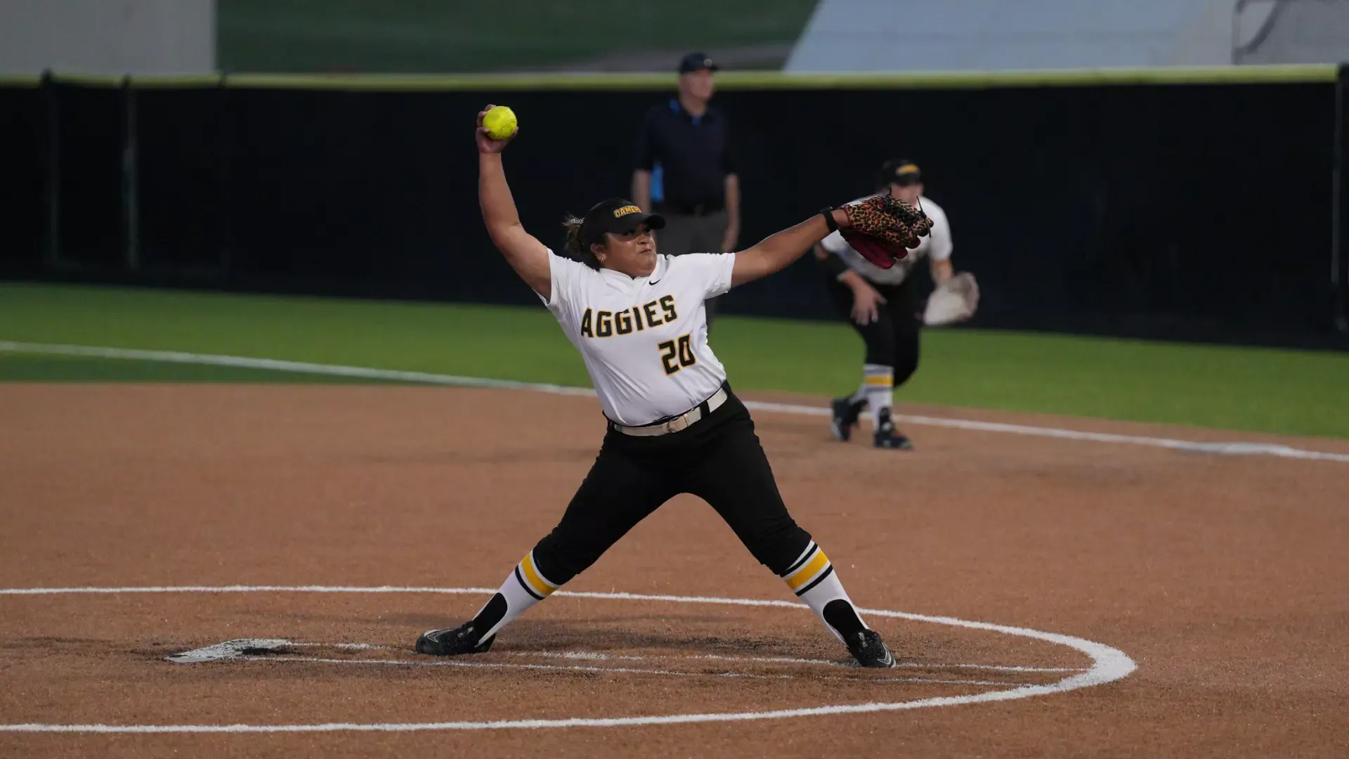 Cameron softball pitcher, Stormee Reed, in the middle of her windup about to throw a pitch