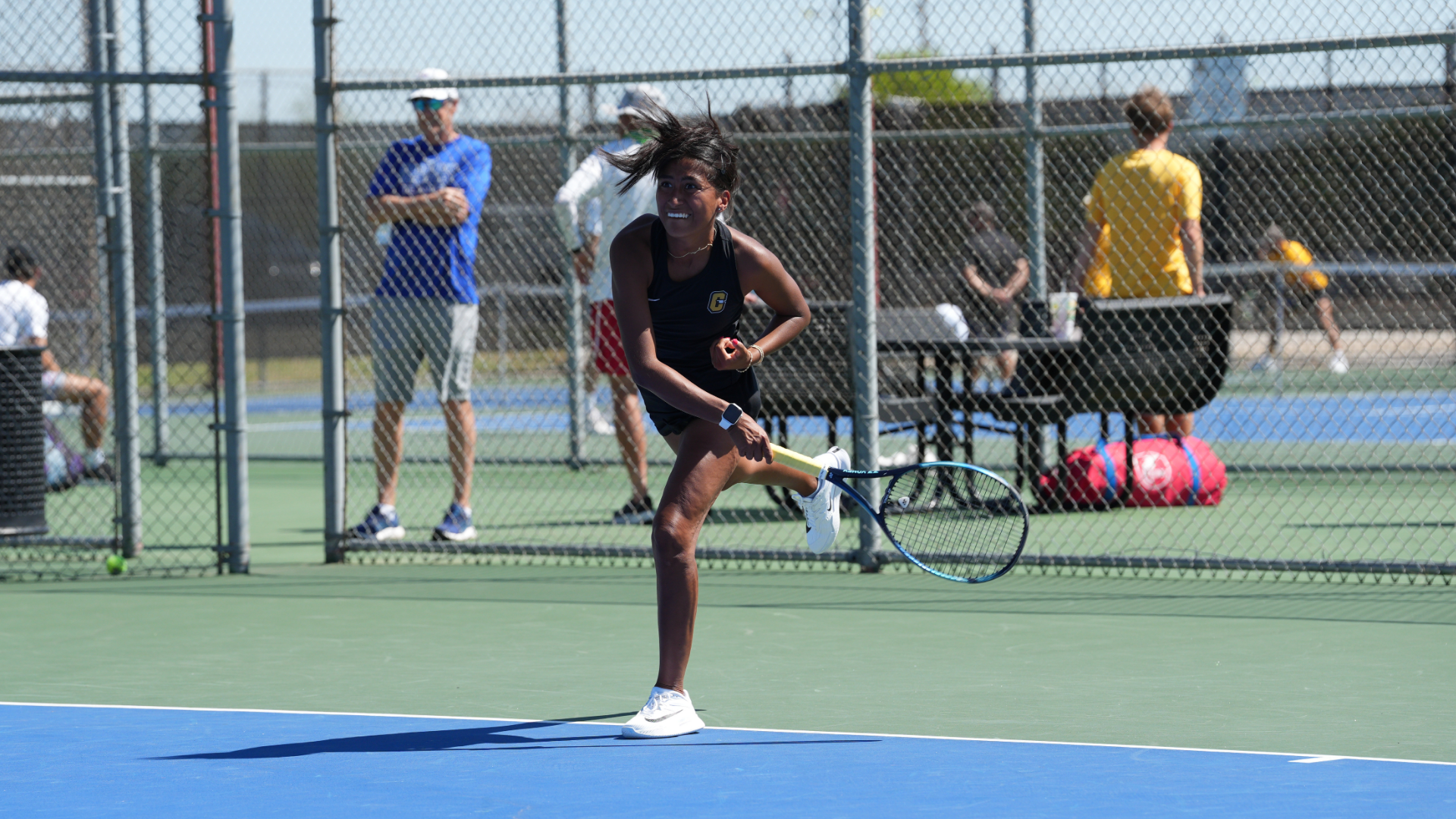 Cameron women's tennis player hitting a serve