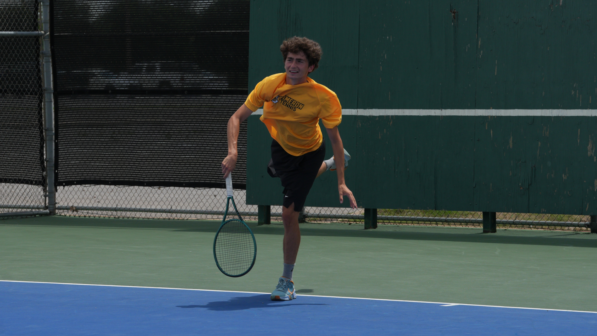 Ulysse Esphahani following through after hitting a serve