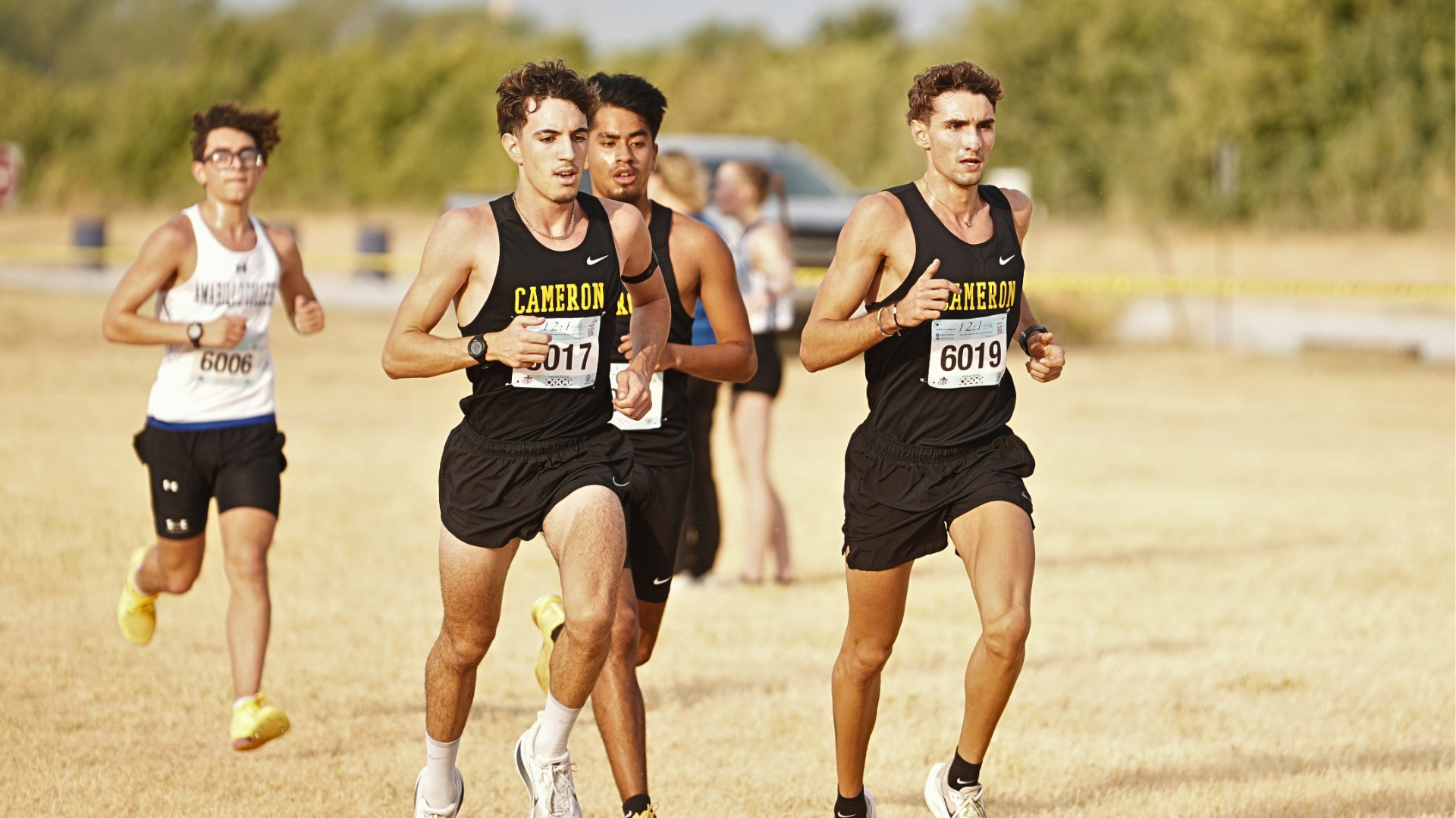 Cameron Men’s cross country group of runners running at the Cameron Invitational