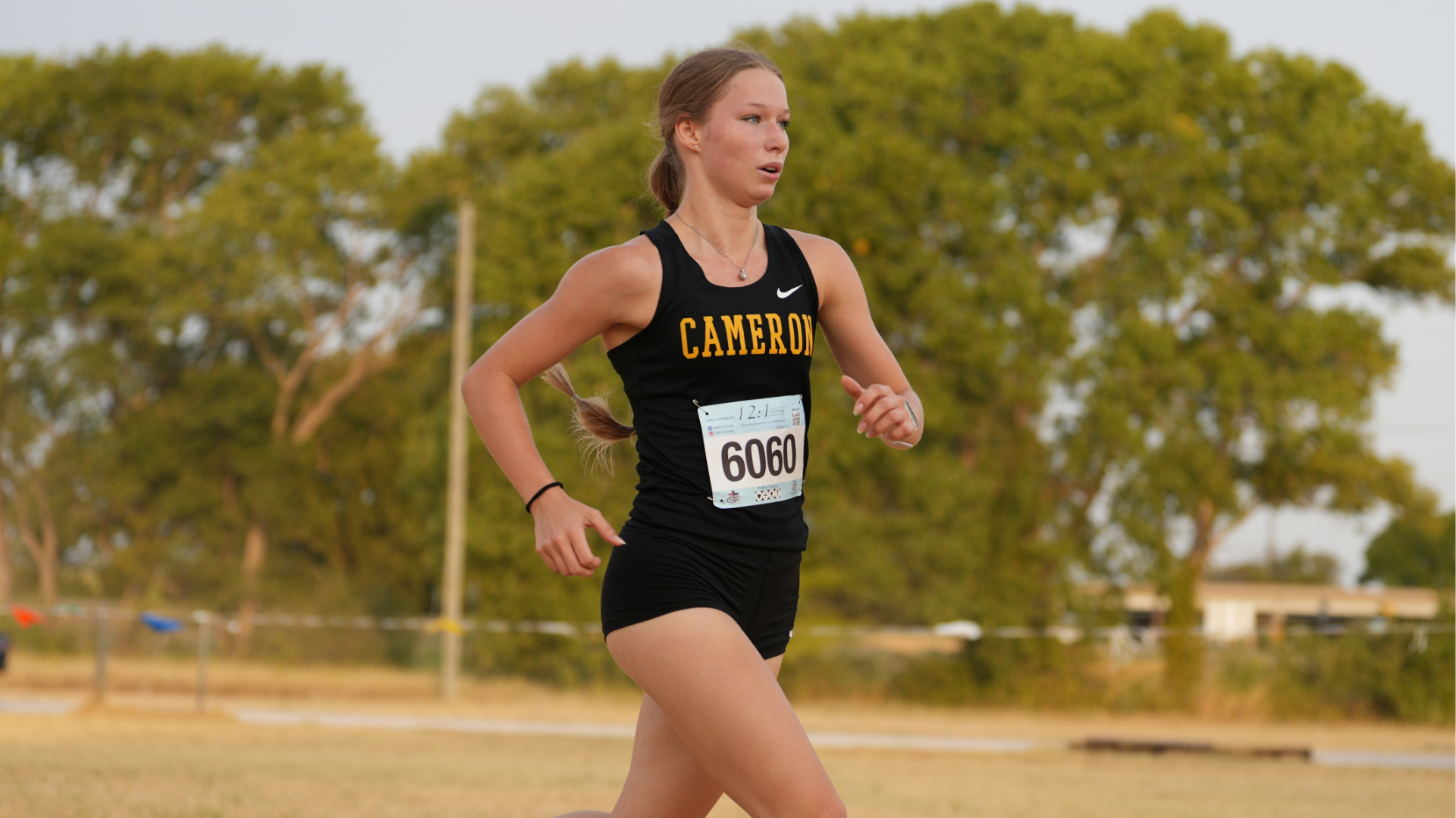 Cameron Women’s cross country runner running at the Cameron Invitational