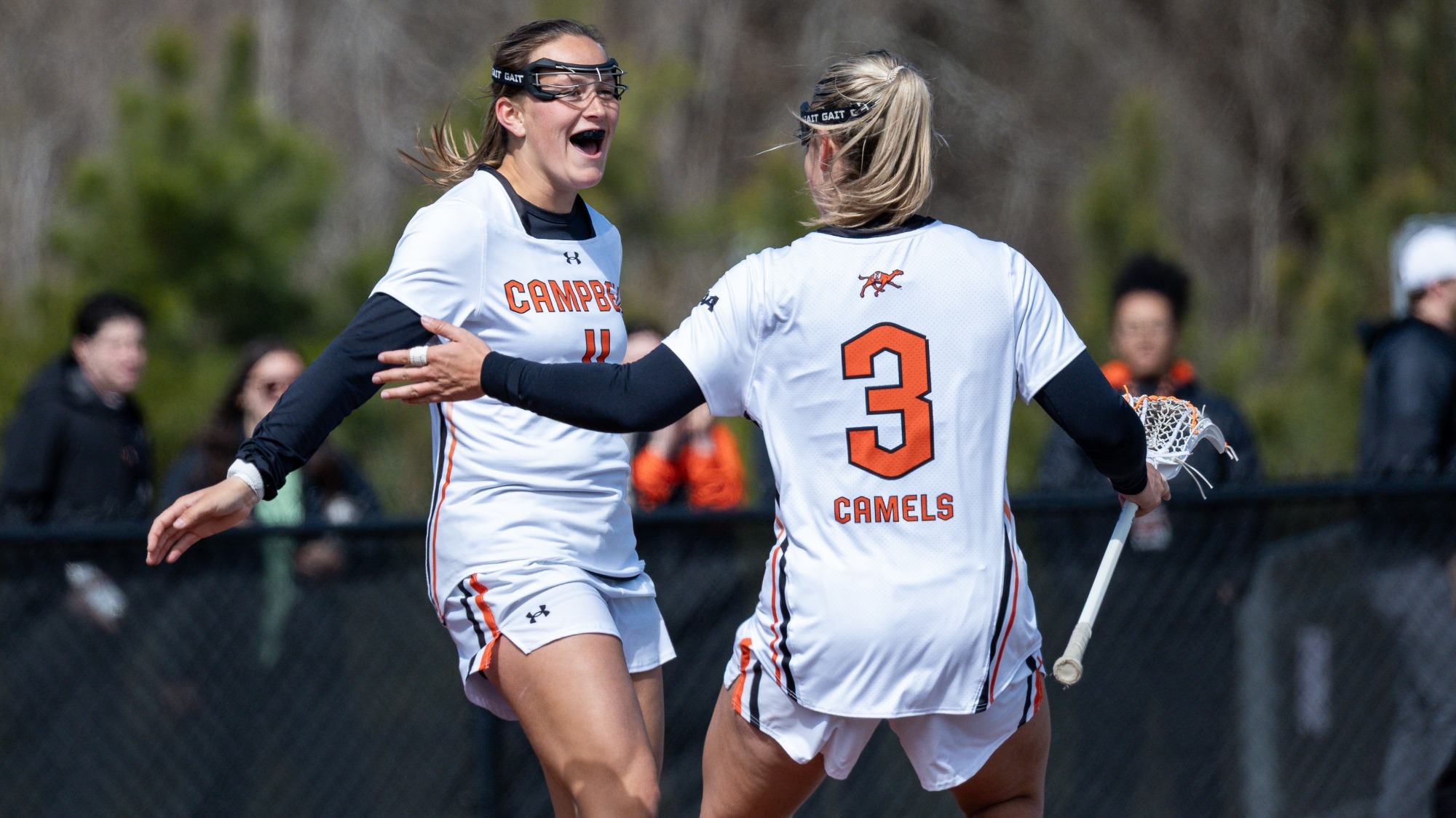 Paige White celebrating with teammate #3 McKenna Duncan