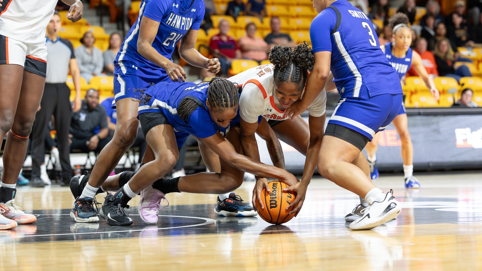 Jasmine Felton fighting two Hampton players for a loose ball