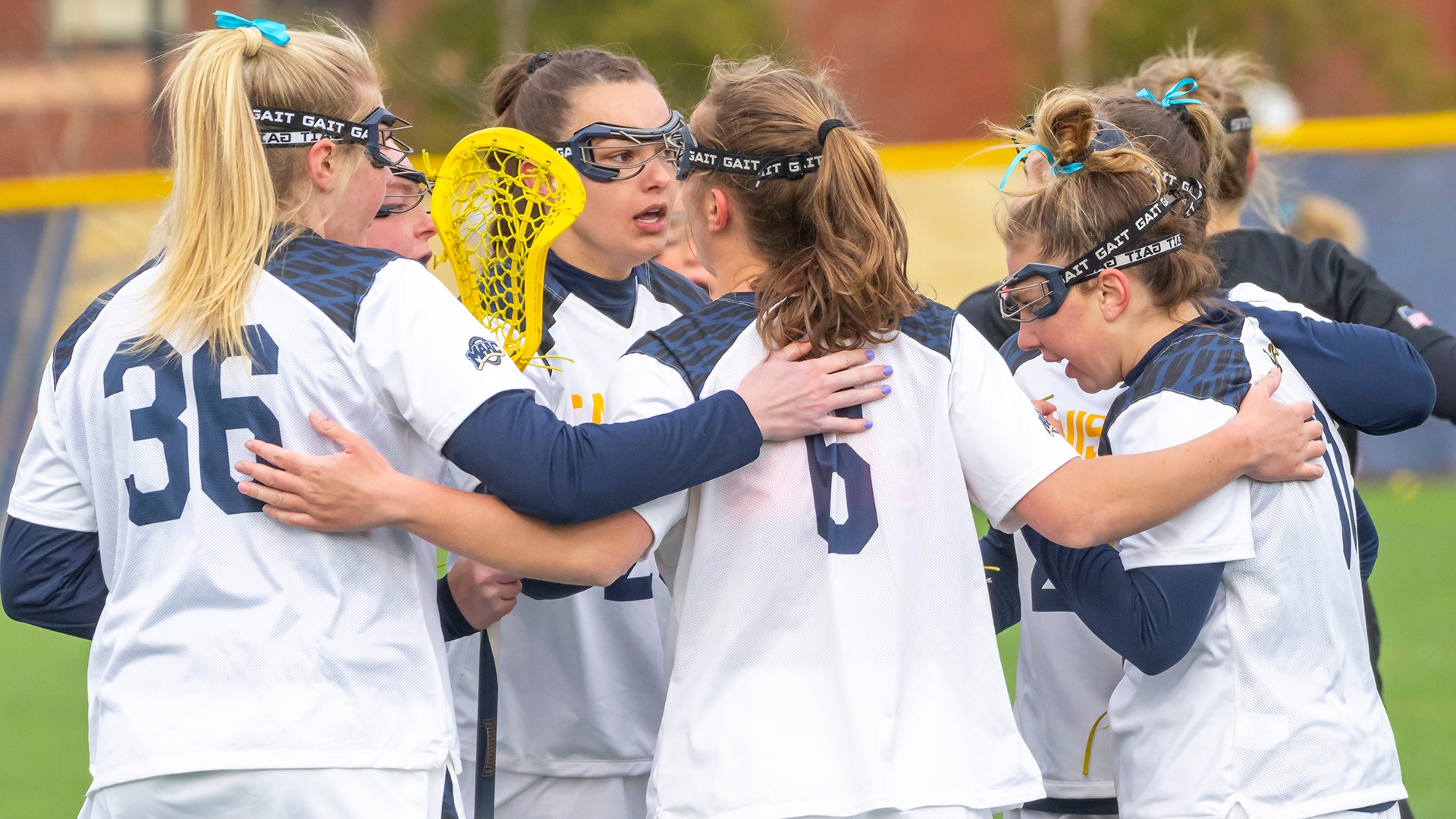Members of the Canisius women's lacrosse team huddle during game action at the Demske Sports Complex 
