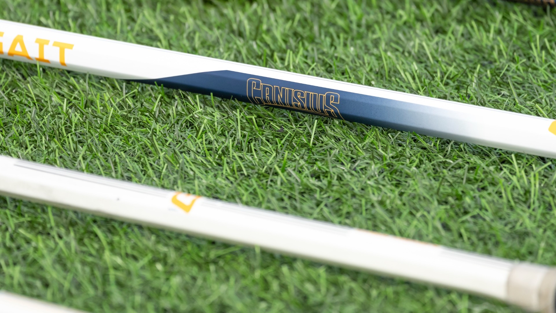 A lacrosse stick sits on the ground of the Demske Sports Complex.