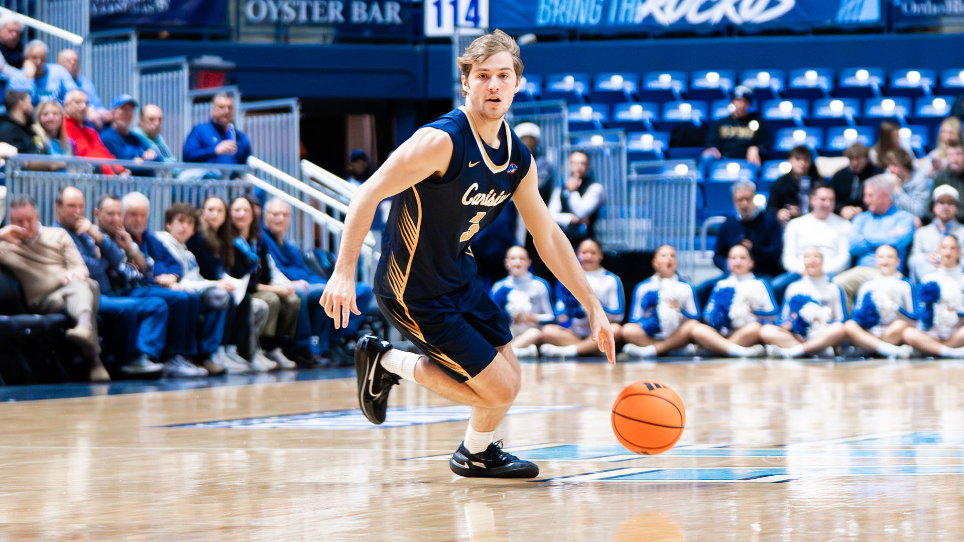 Anthony Benard looks to make a pass in the first half of a road game at Rhode Island Dec. 16, 2025.