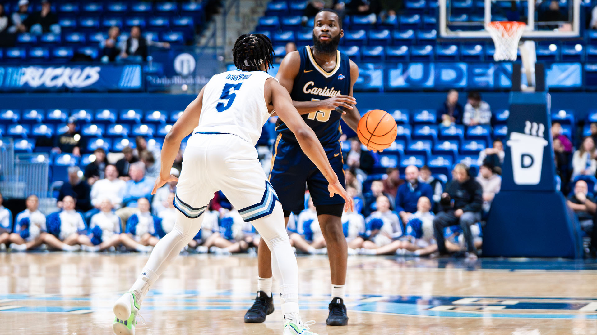 Mike Evbagharu looks to make a pass in the first half of a road game at Rhode Island on Dec. 16, 2025.
