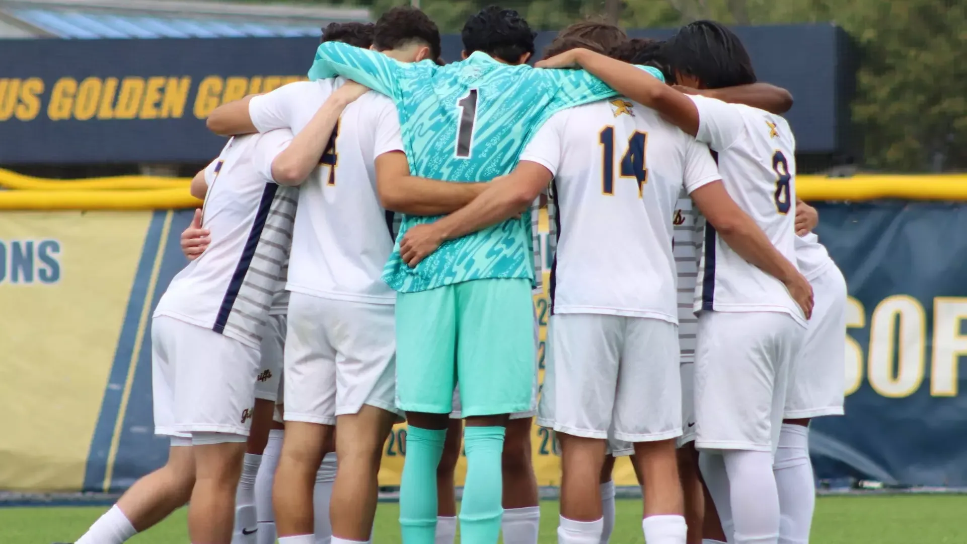 Canisius players Mason Petrucci, Henrique Dias, Preston Harold, Kyle Pollard, and Edson Flores huddle before kickoff vs. Duquesne on August 30, 2025.