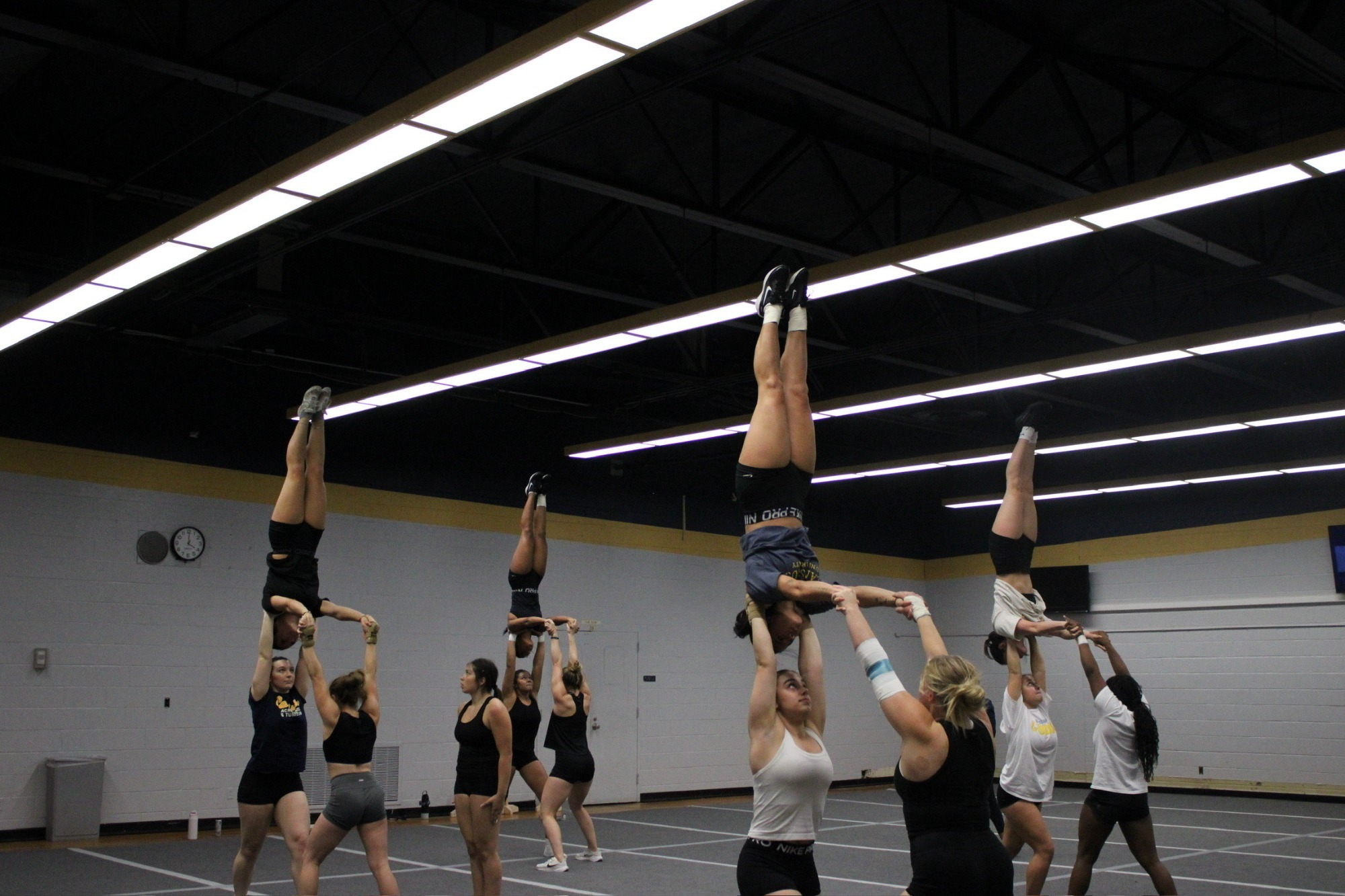 The Acrobatics and Tumbling team practices in the auxiliary gym on an unknown date.
