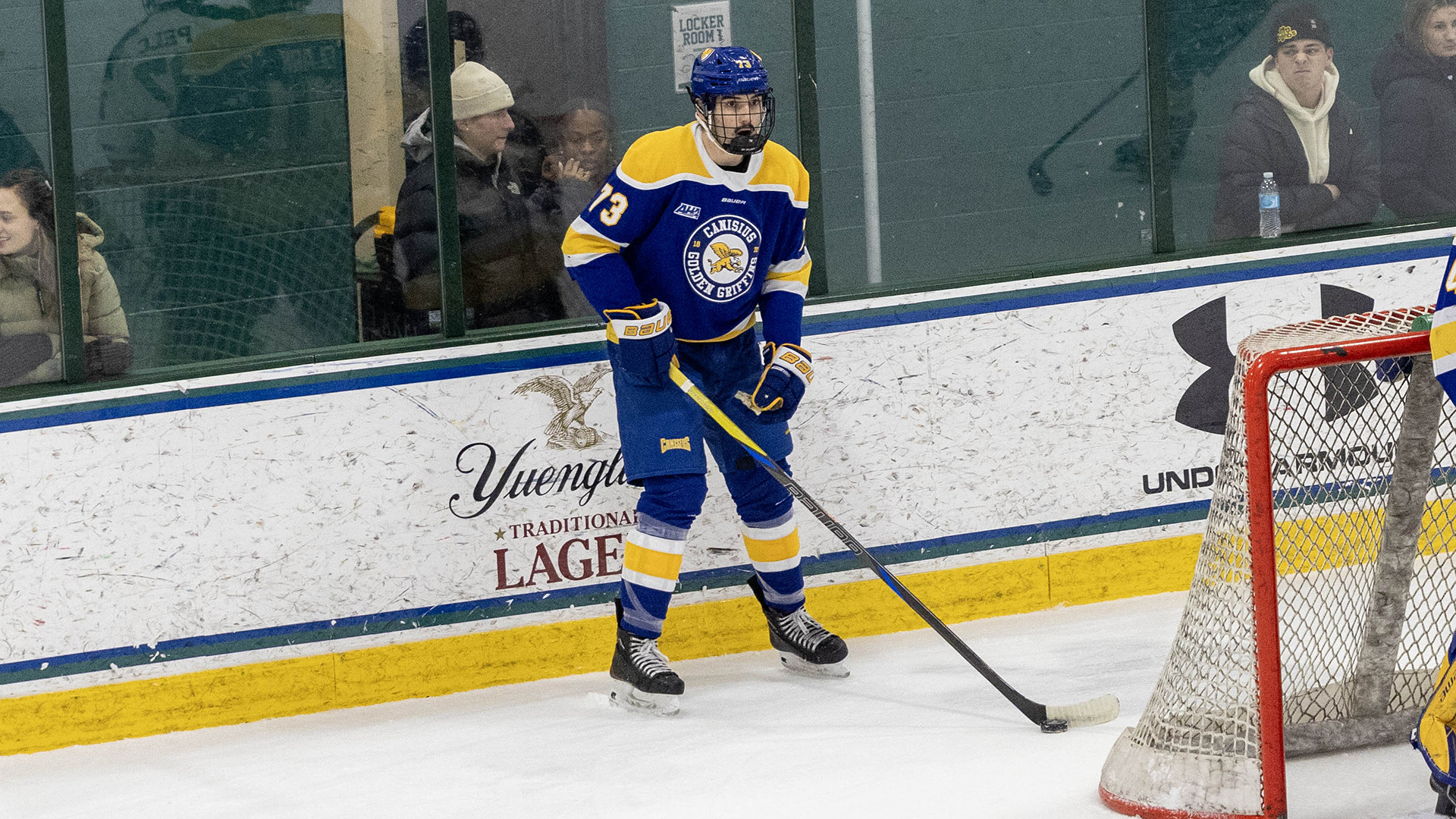 Canisius defenseman FJ Buteau is shown standing with the puck behind the net in action versus Mercyhurst at the Mercyhurst Ice Center in Erie, Pa.