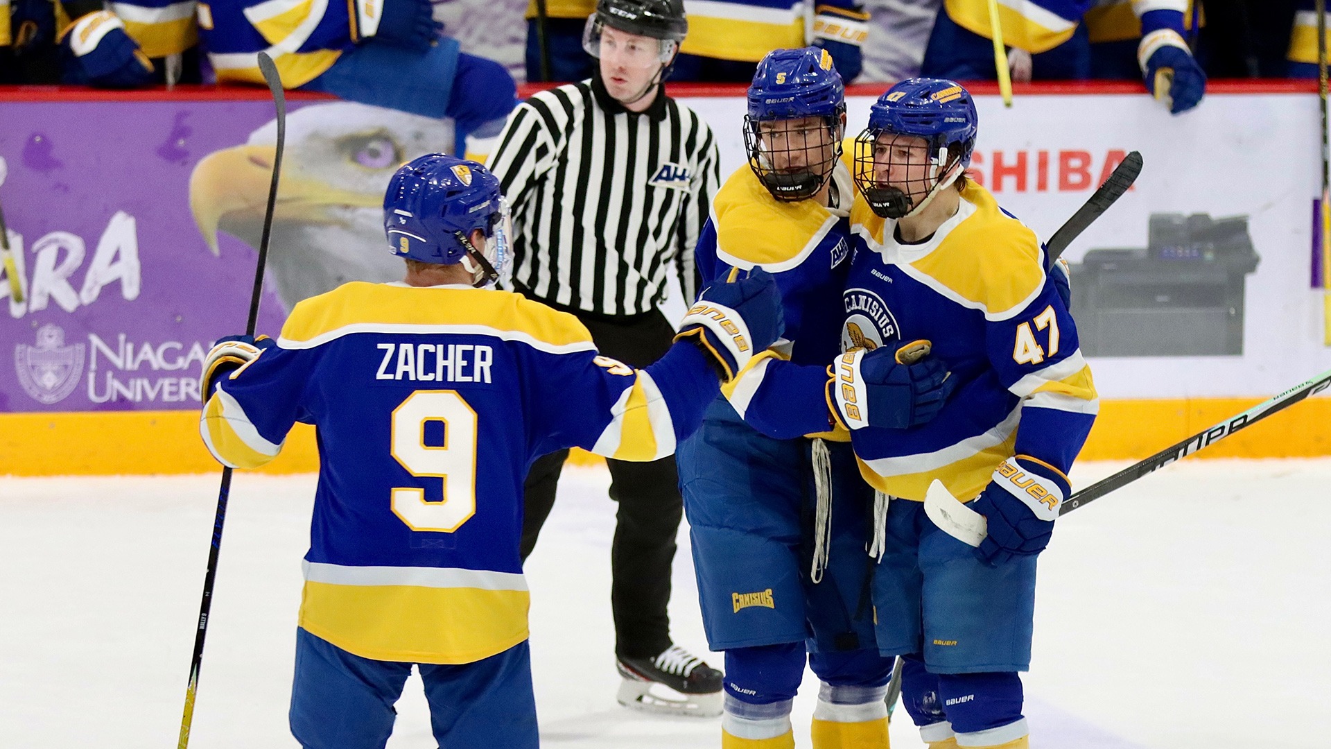 Walter Zacher (left) joins Robert Kincaid (middle) and Grant Porter (right) in a celebration after Porter scored the first of his two goals in the Griffs 4-3 victory at Niagara on Jan. 31, 2026