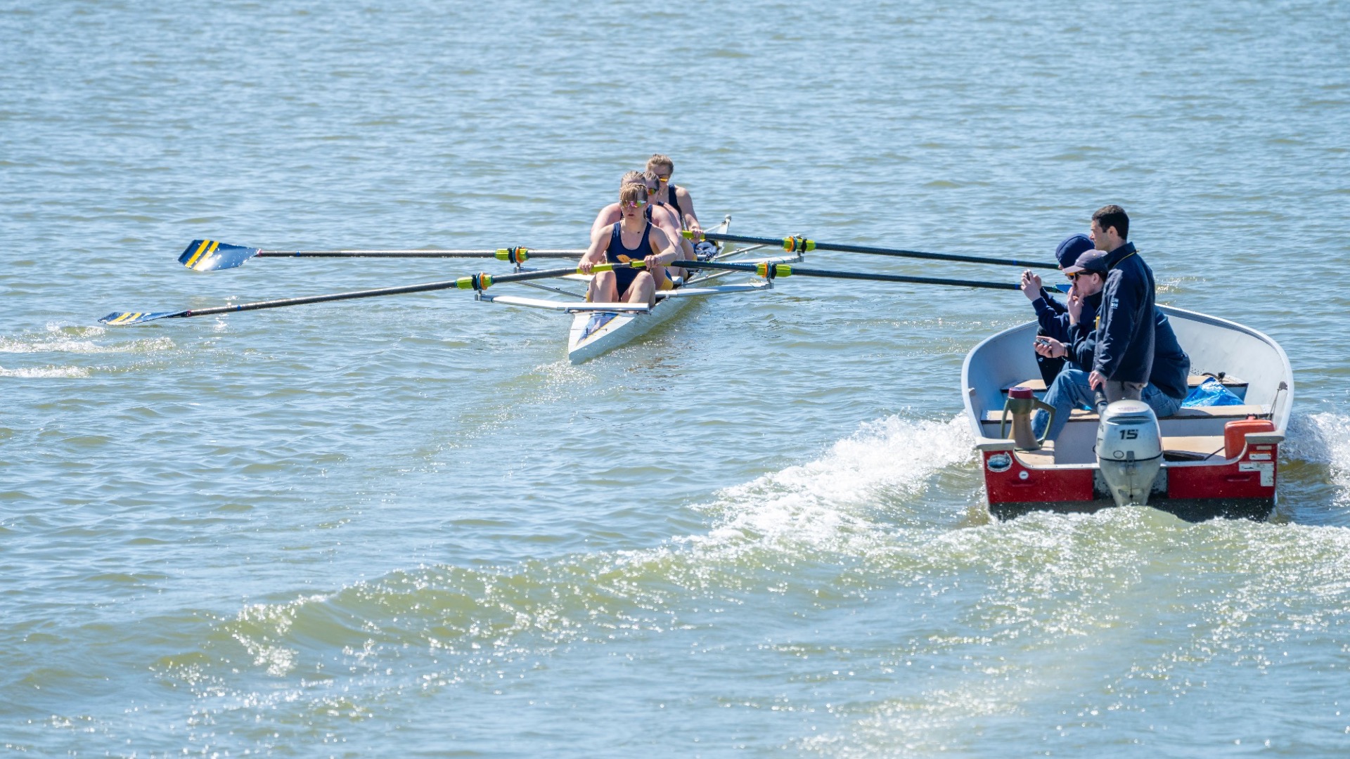 Canisius rowing being timed by head coach Matt Cosmann