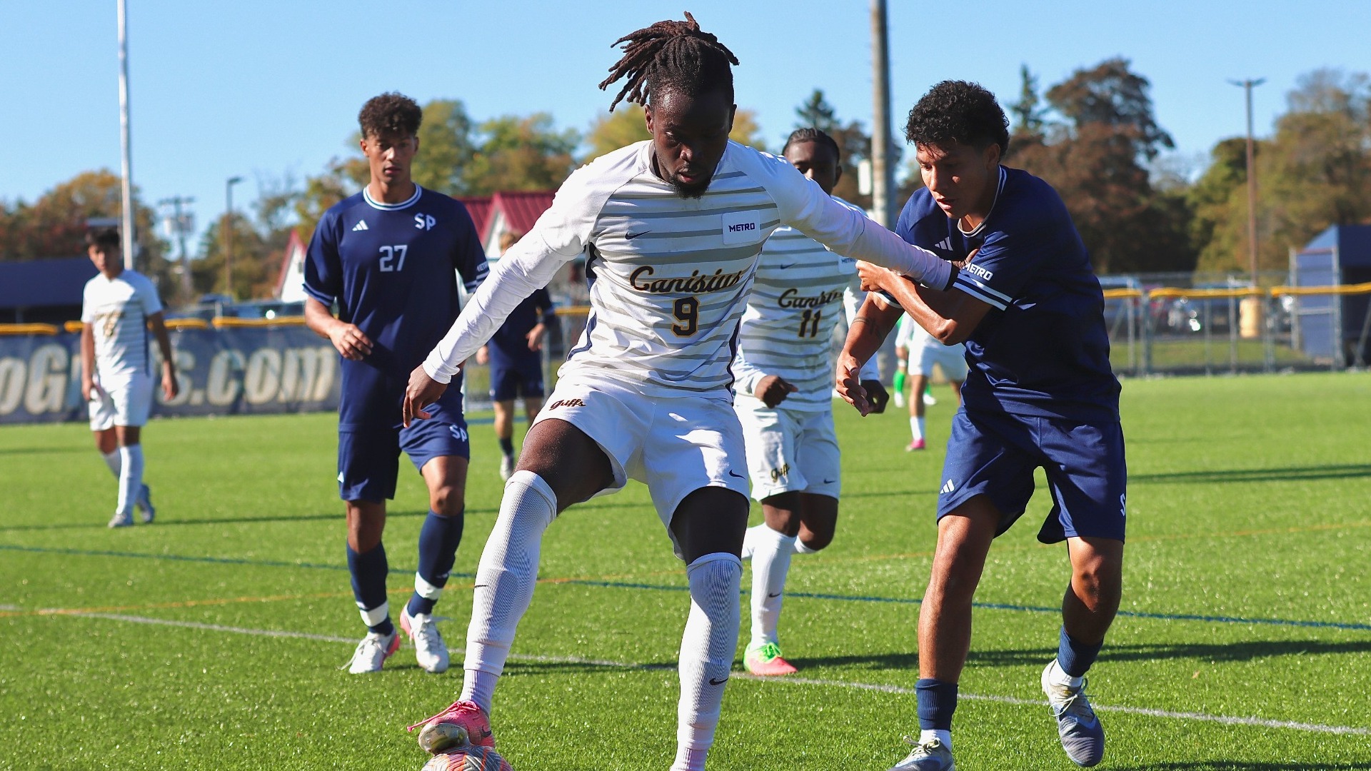 Sydney Aggrey battles for the ball against a defender vs Saint Peter's - Oct. 17, 2026